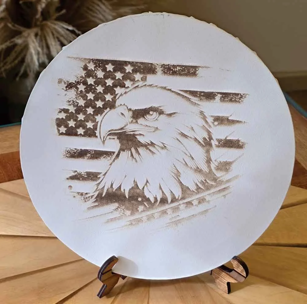 An engraved plate featuring an American flag with stars and stripes and a detailed eagle's head in front of the flag.