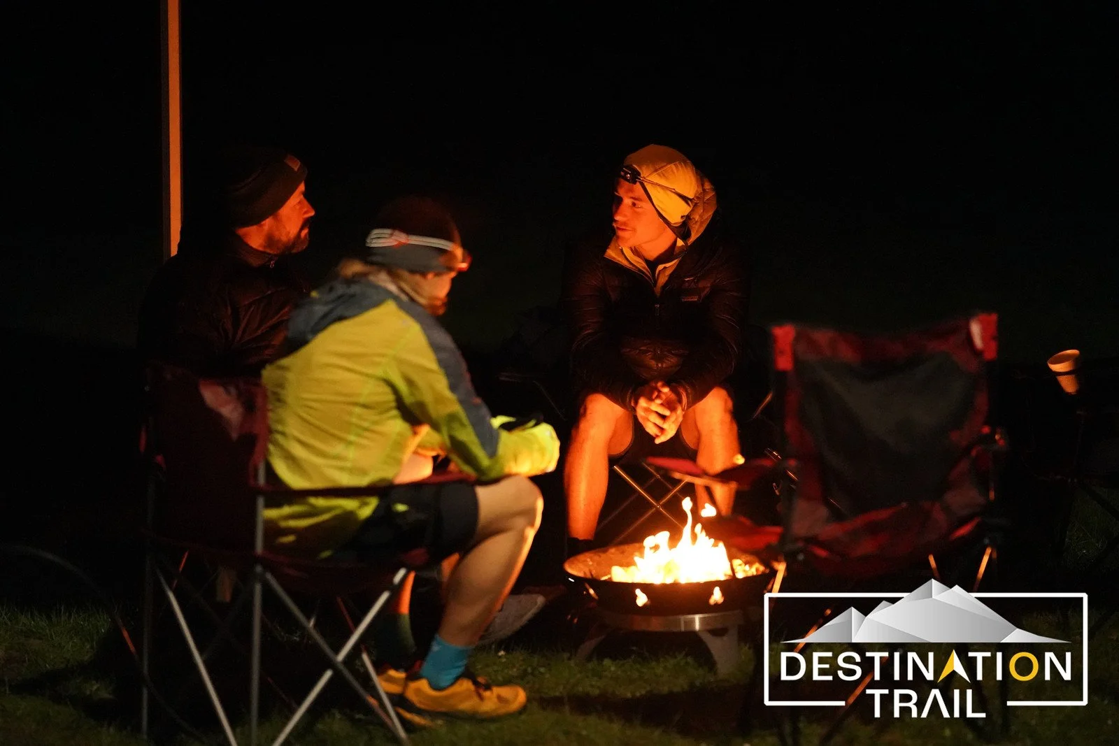 Runners gathered around a fire pit in the dark at the beginning of Orcas Island trail races