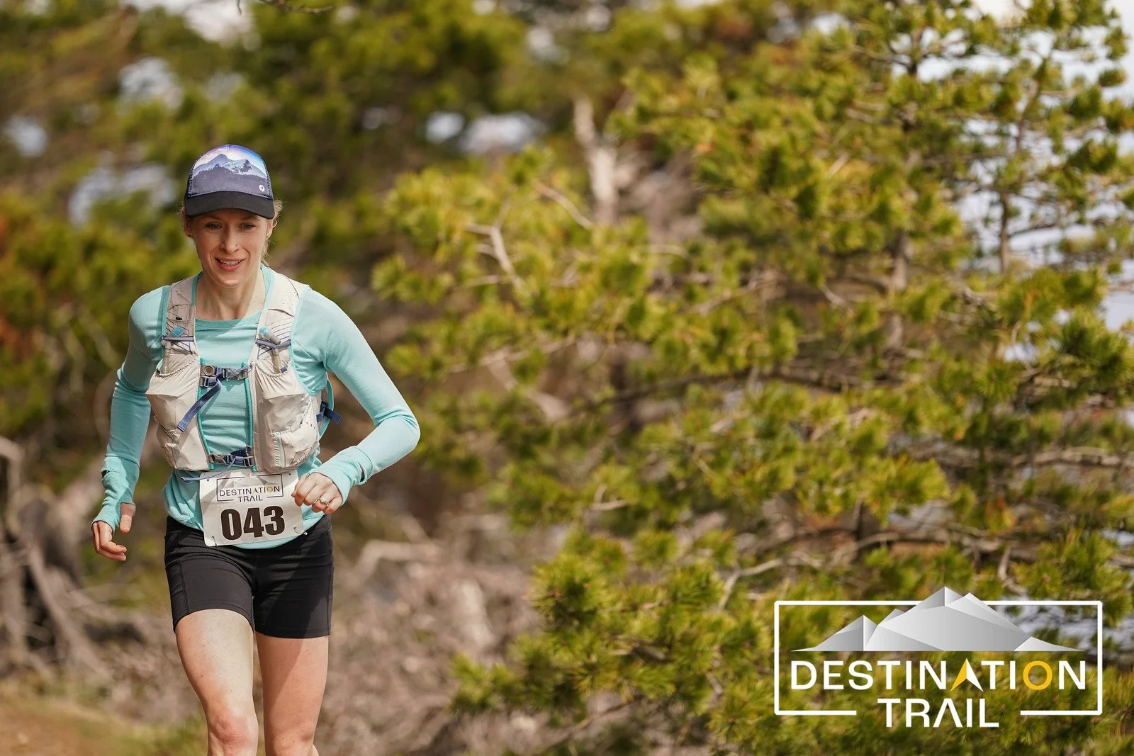 A close-up of a female runner in a forest of pine trees on Orcas Island