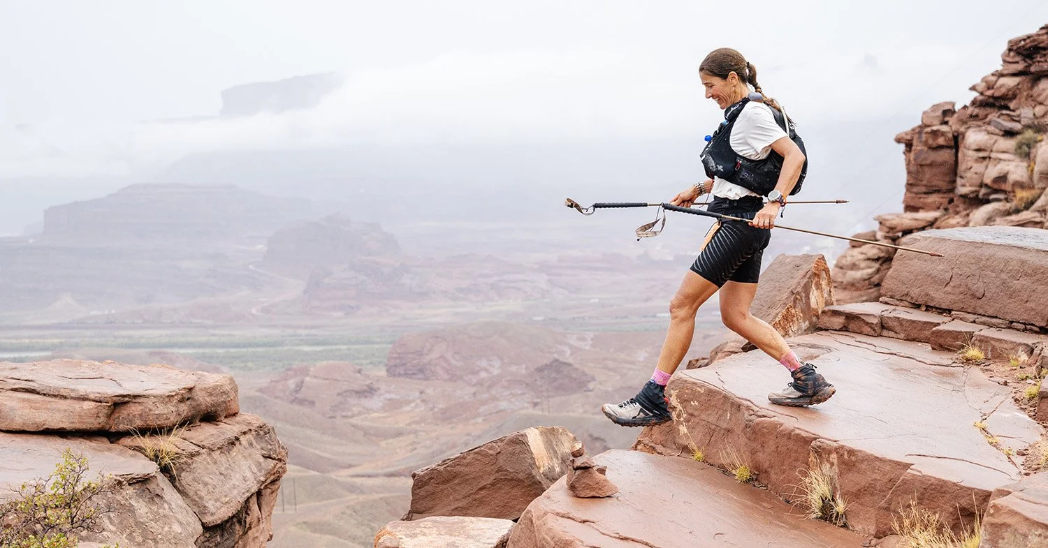A runner in Moab running over rocks