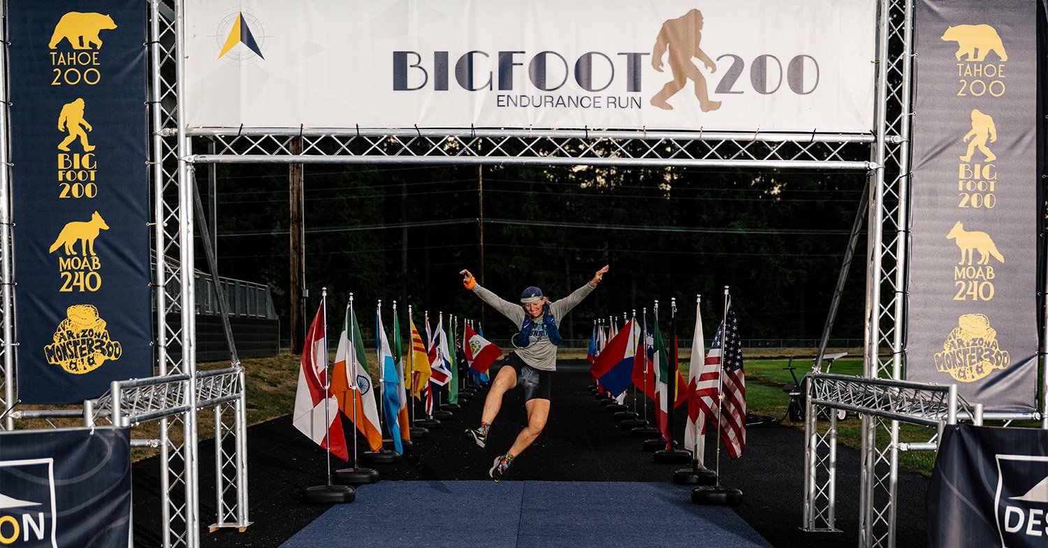 A runner celebrates at the finish line of the Bigfoot 200 Endurance Run