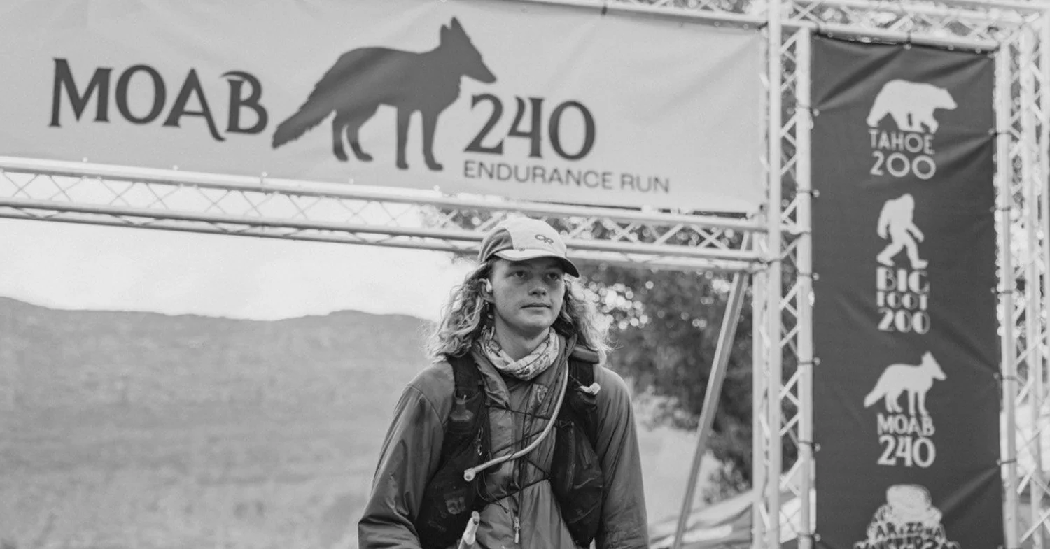 Runner Carter Burnham crosses the finish line at the Moab 240.