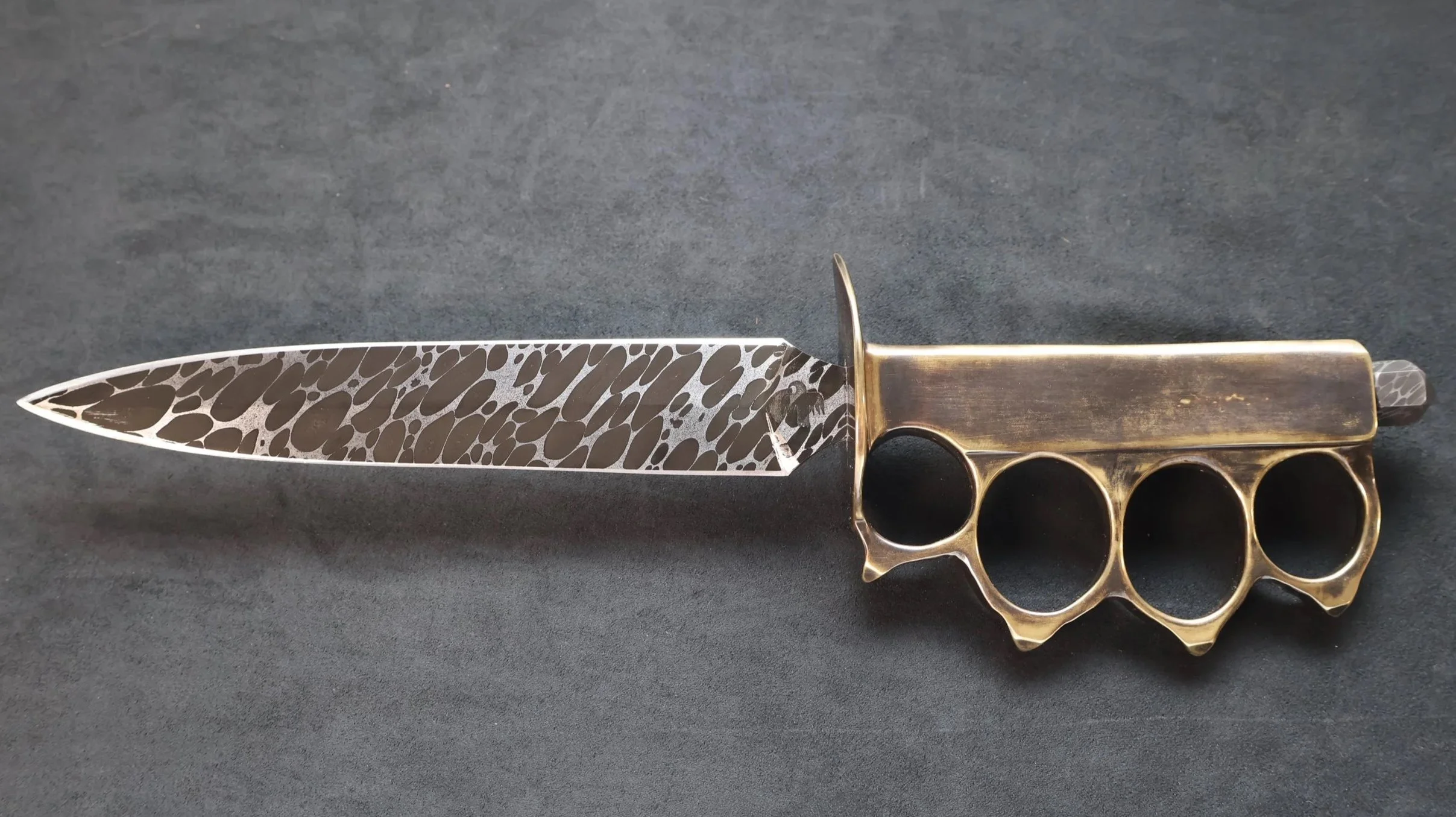 A WW1 Mk. 1 Trench Knife with Damascus blade made from ball bearings and a cast brass handle. Made by Monty Wheeler.