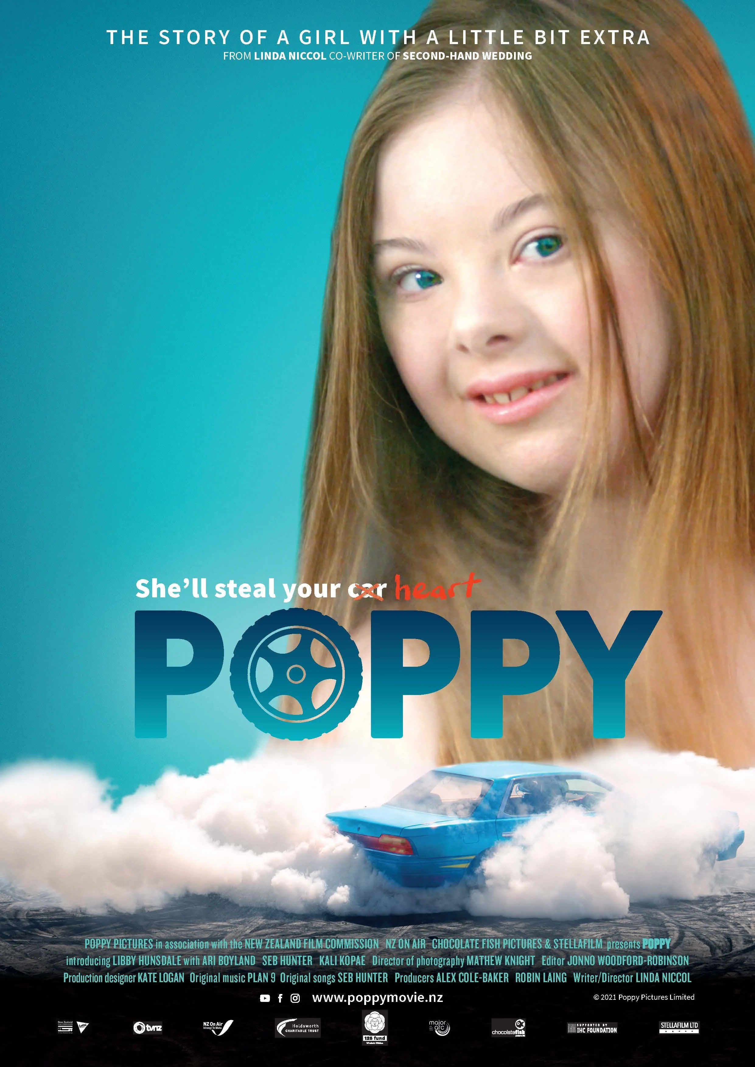Movie poster for 'Poppy' featuring a girl with long red hair, blue eyes, and a slight smile, with a blue car surrounded by clouds below her. The text indicates it's a story about a girl with a little extra, with the tagline 'She'll steal your heart'.