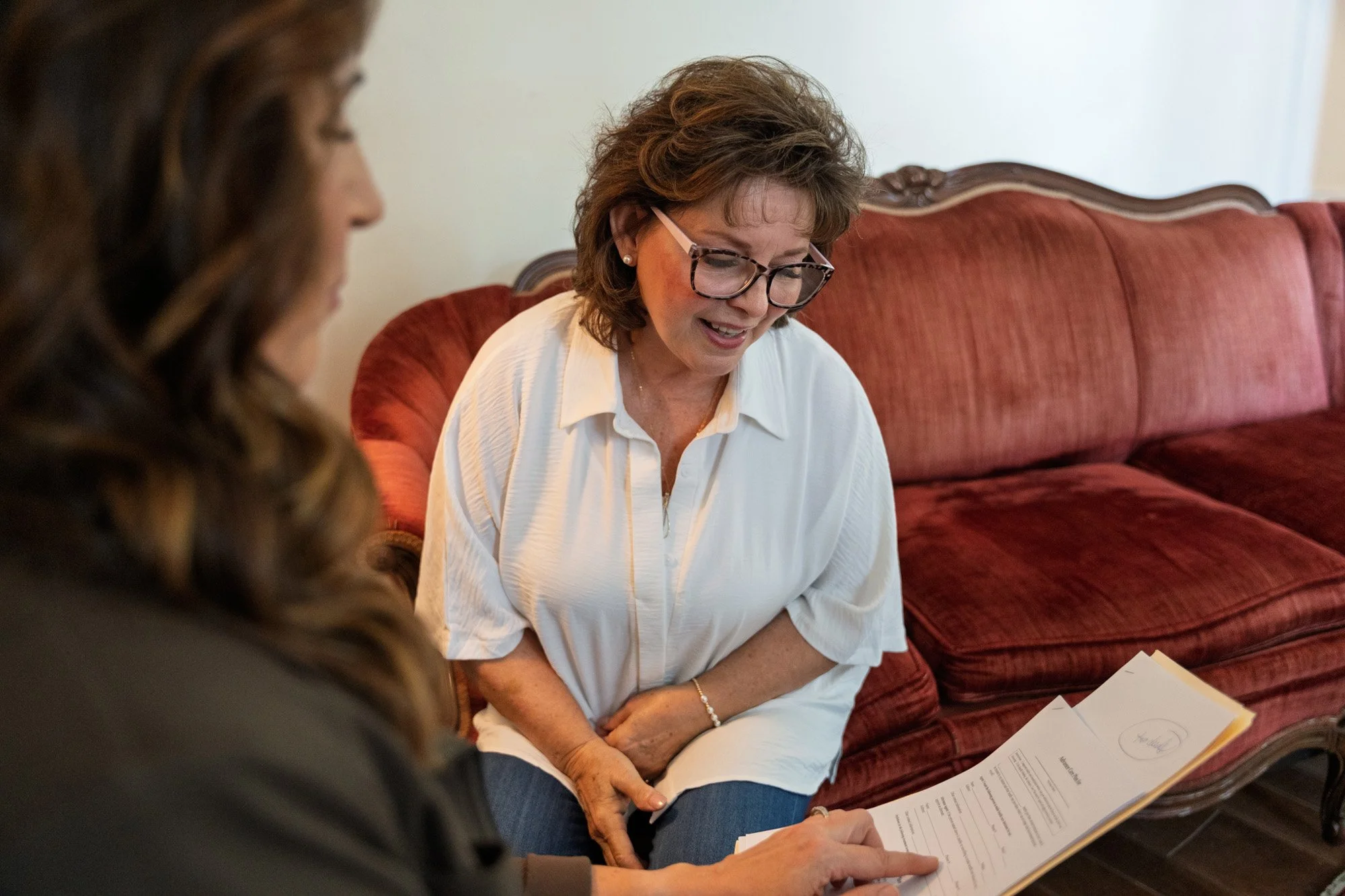 Angela Snider talking through paperwork with client.