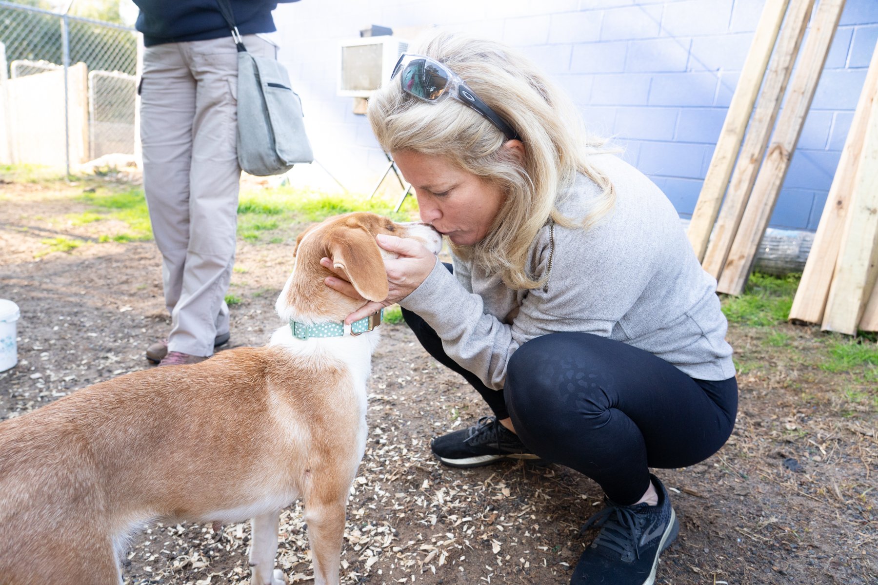 Woman kissing dog