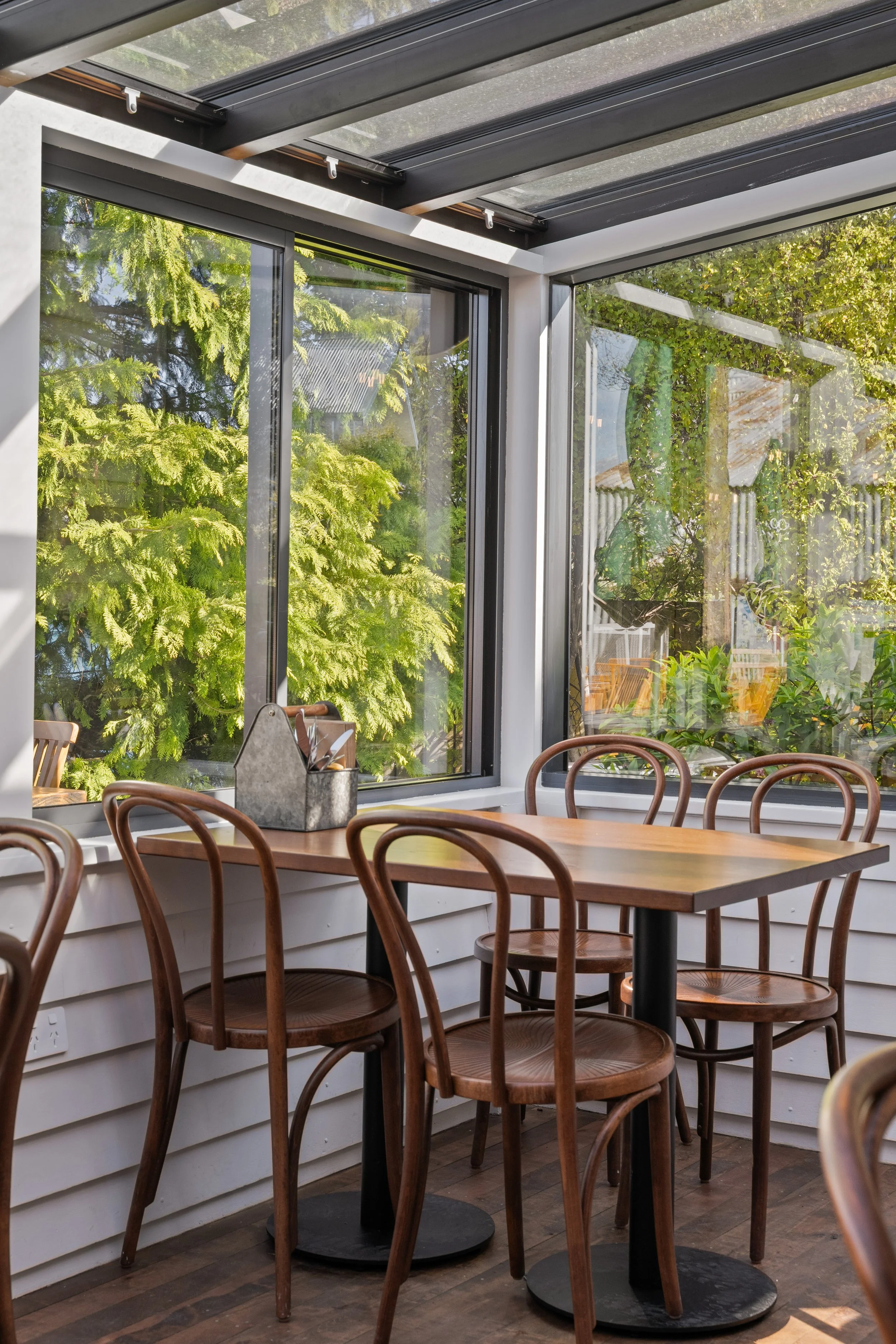 Window seating with bentwood chairs and garden outlook, Boat Shed Cafe interior