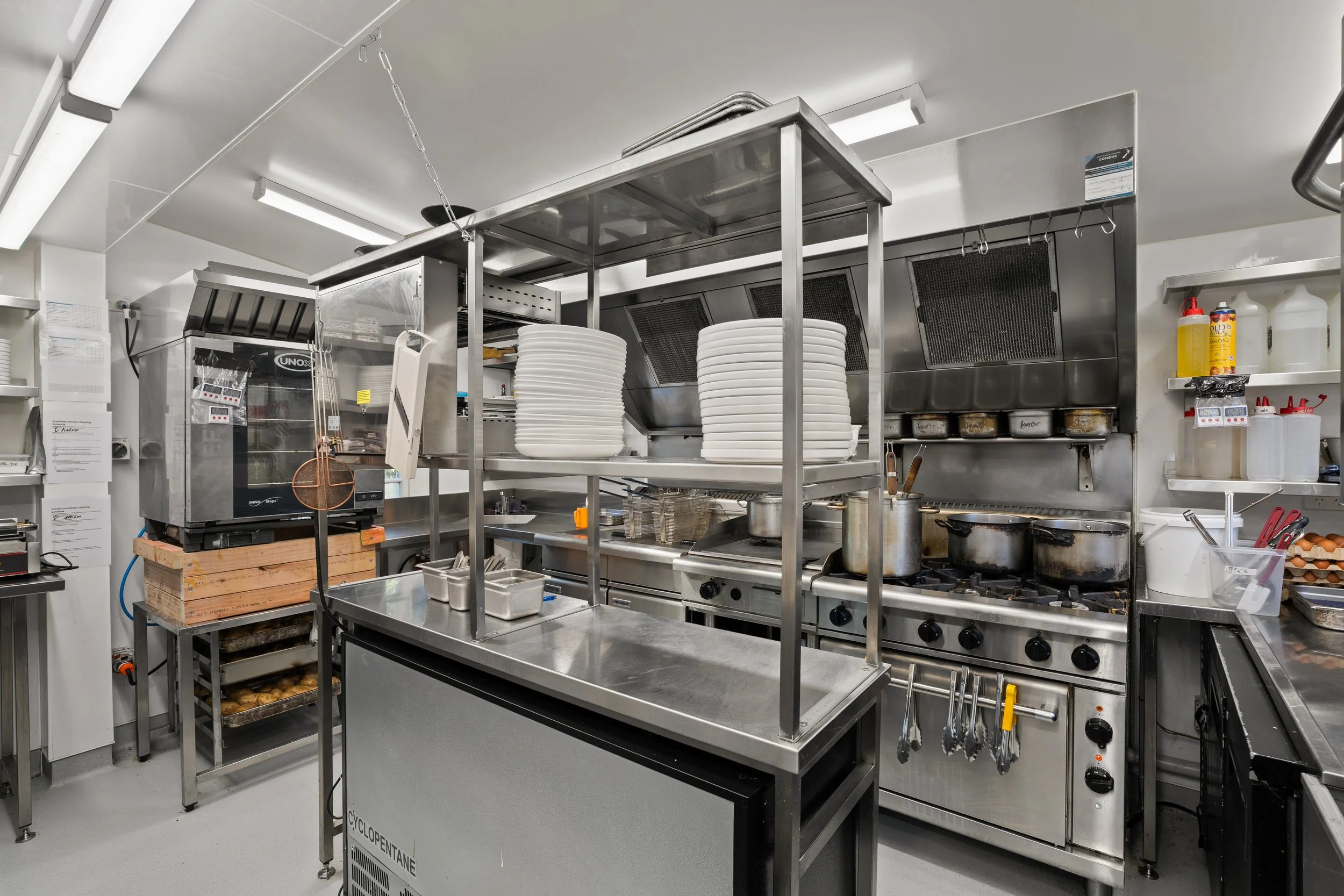 Commercial kitchen fit-out with stainless steel shelving and prep bench, Queenstown cafe