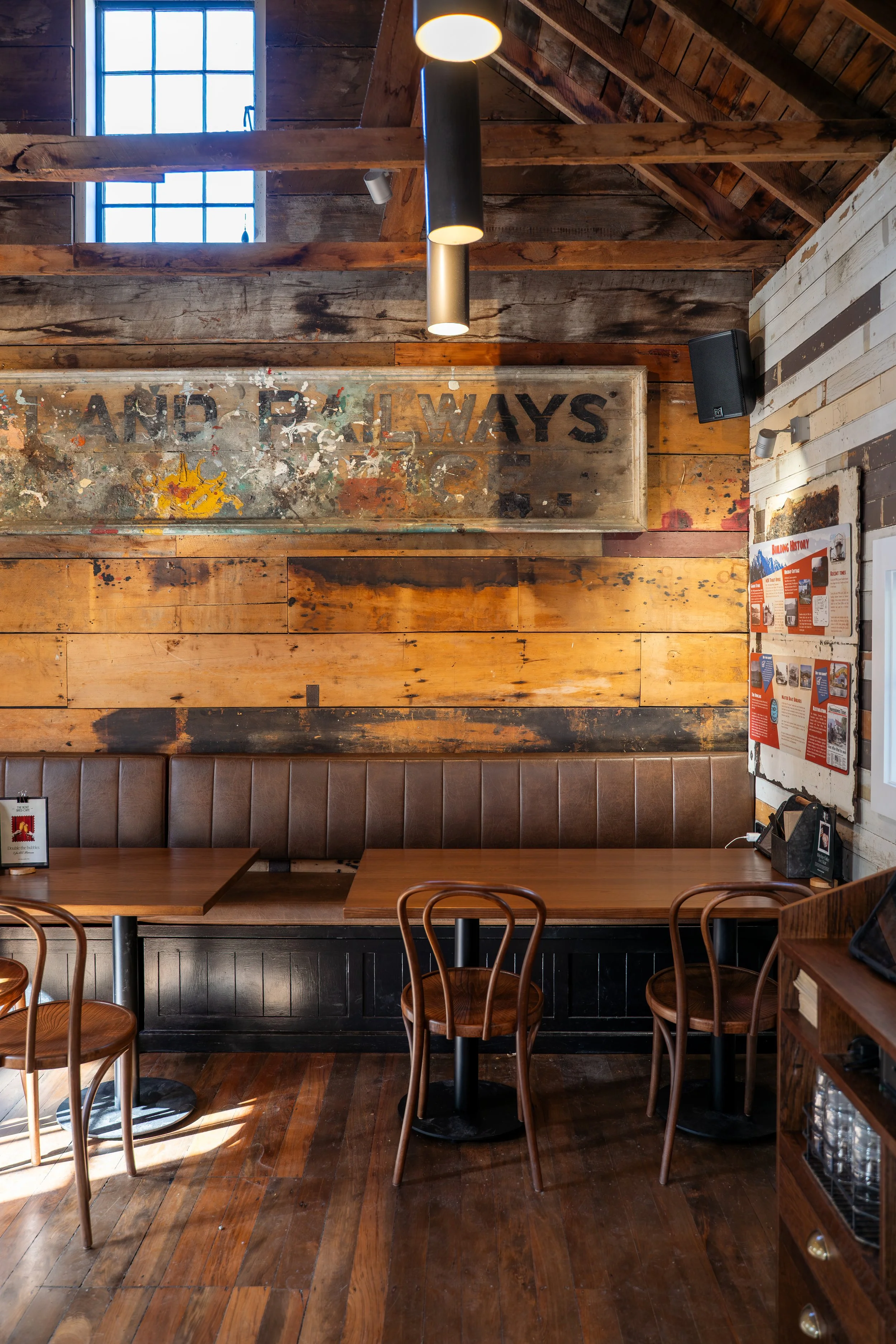 Banquette seating against reclaimed timber feature wall, Boat Shed Cafe interior renovation
