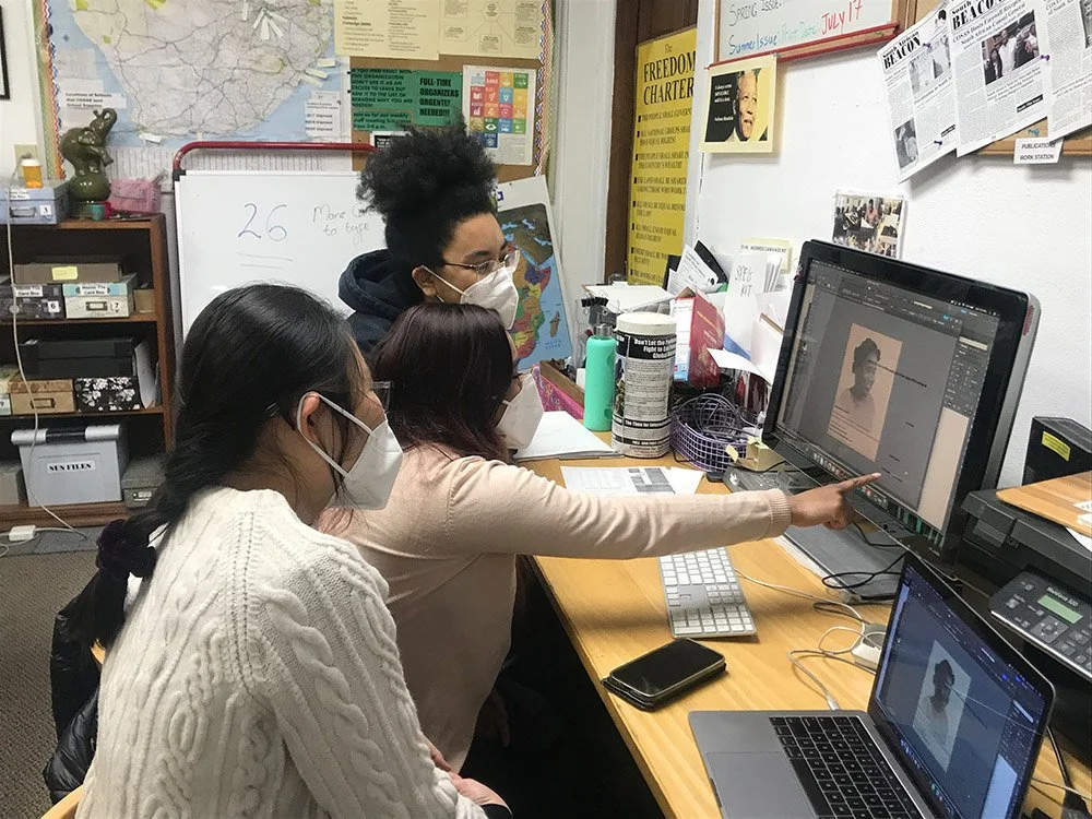 Three volunteers working on a publication session