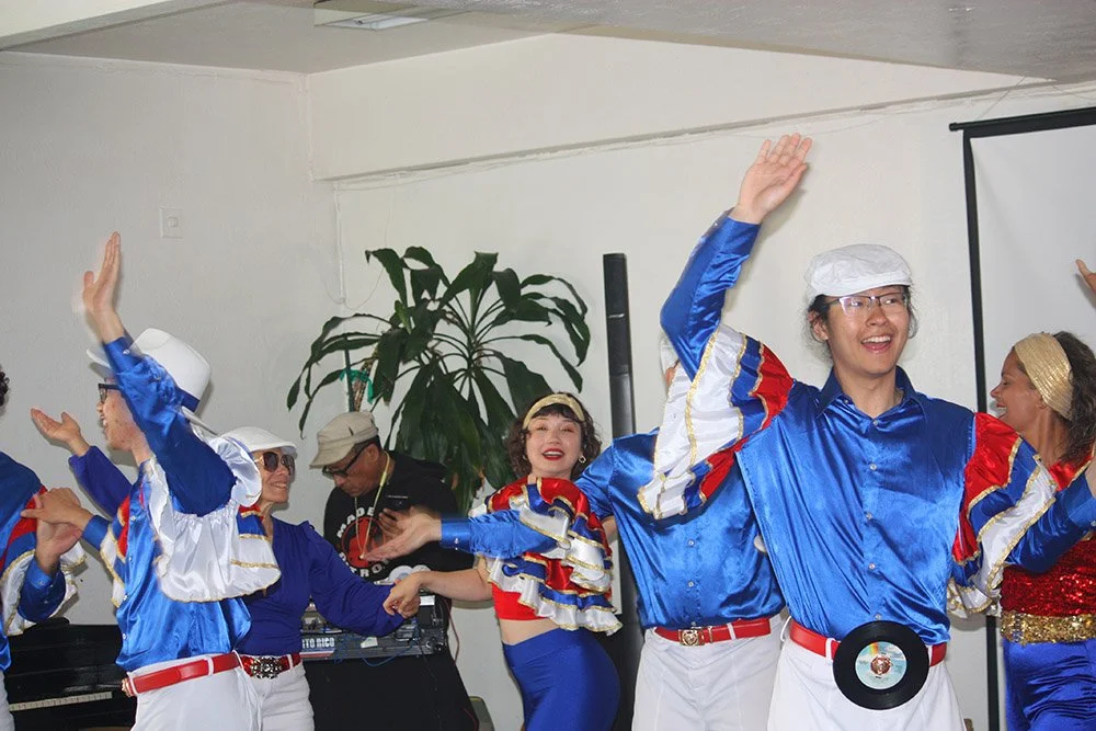 Rueda Con Ritmo salsa dancers at COSAS' Day of Solidarity event.