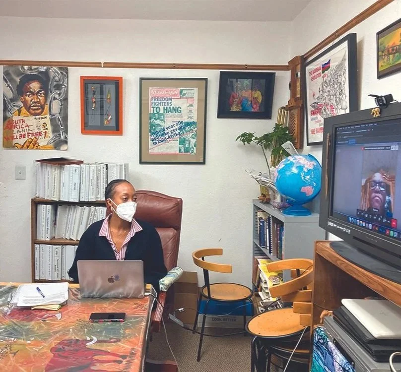 A COSAS organizer wearing a mask speaking via a video conference to a COSAS member
