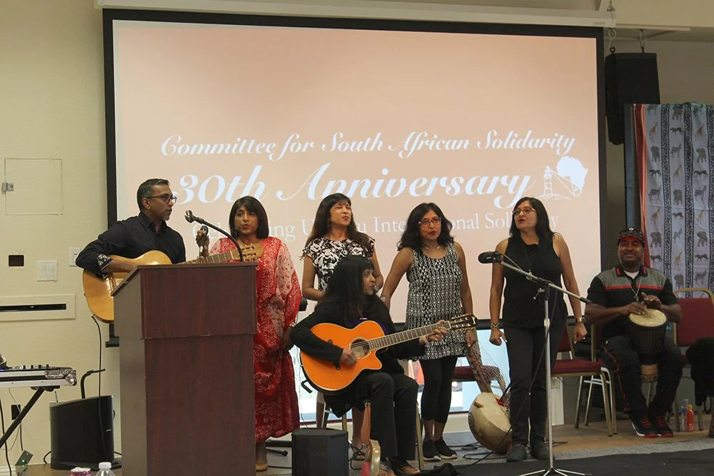 Moonsamy family (left to right standing), Neil, Noelene, Susheela, Ursula, Priscilla and  Melanie (seated), sing at COSAS' Anniversary Dinner