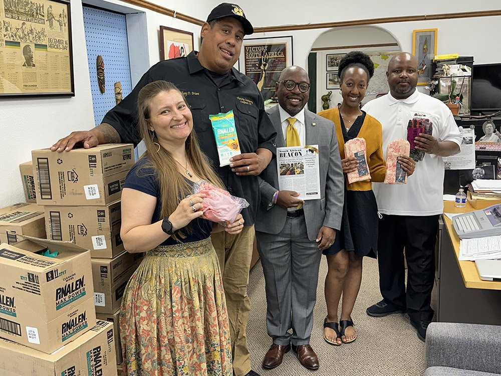 Five COSAS members in the US holding up donated supplies.