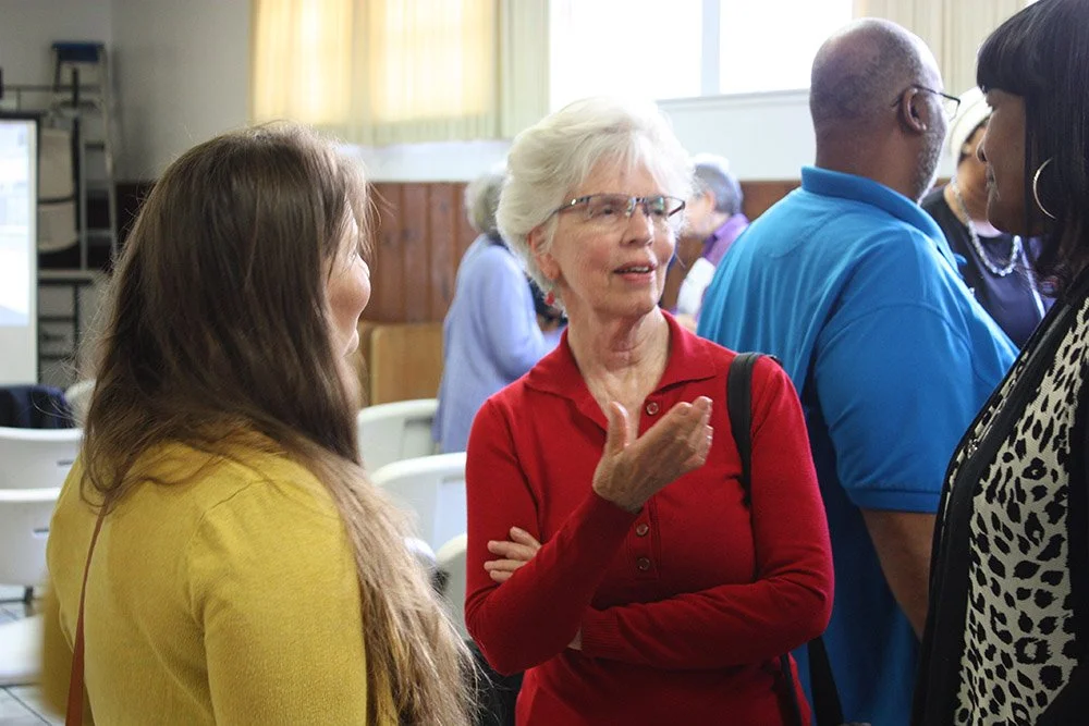 COSAS member Linda Olivenbaum (center) speaks with attendees at COSAS' Day of Solidarity