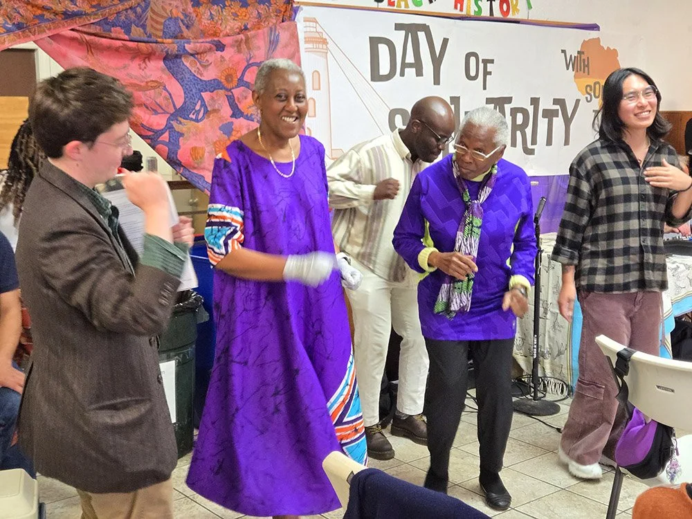 Business owner and COSAS supporter Anna Bimenyimana (second from left) dances at COSAS' Day of Solidarity with other COSAS members.
