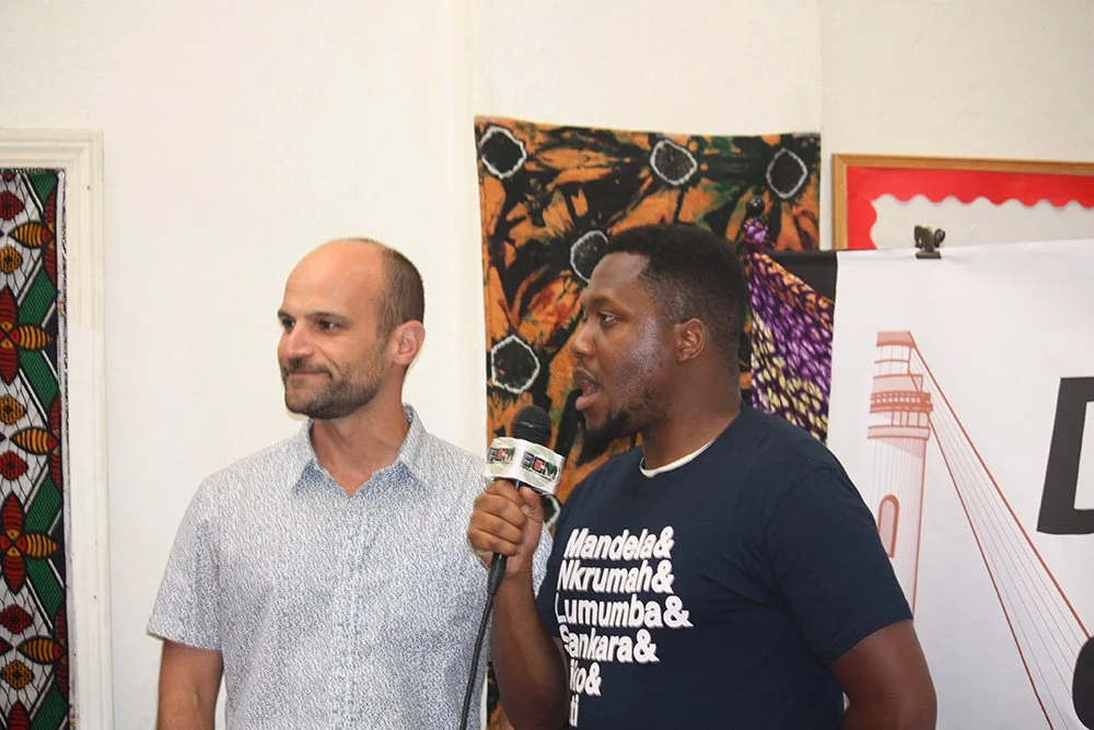 (Left to right) Jaro Fleet Technologies CEO and Founder Joe Miler, Ph.D. with COSAS Board of Directors member Chiedu Ufoegbune speaking at the Day of Solidarity event.