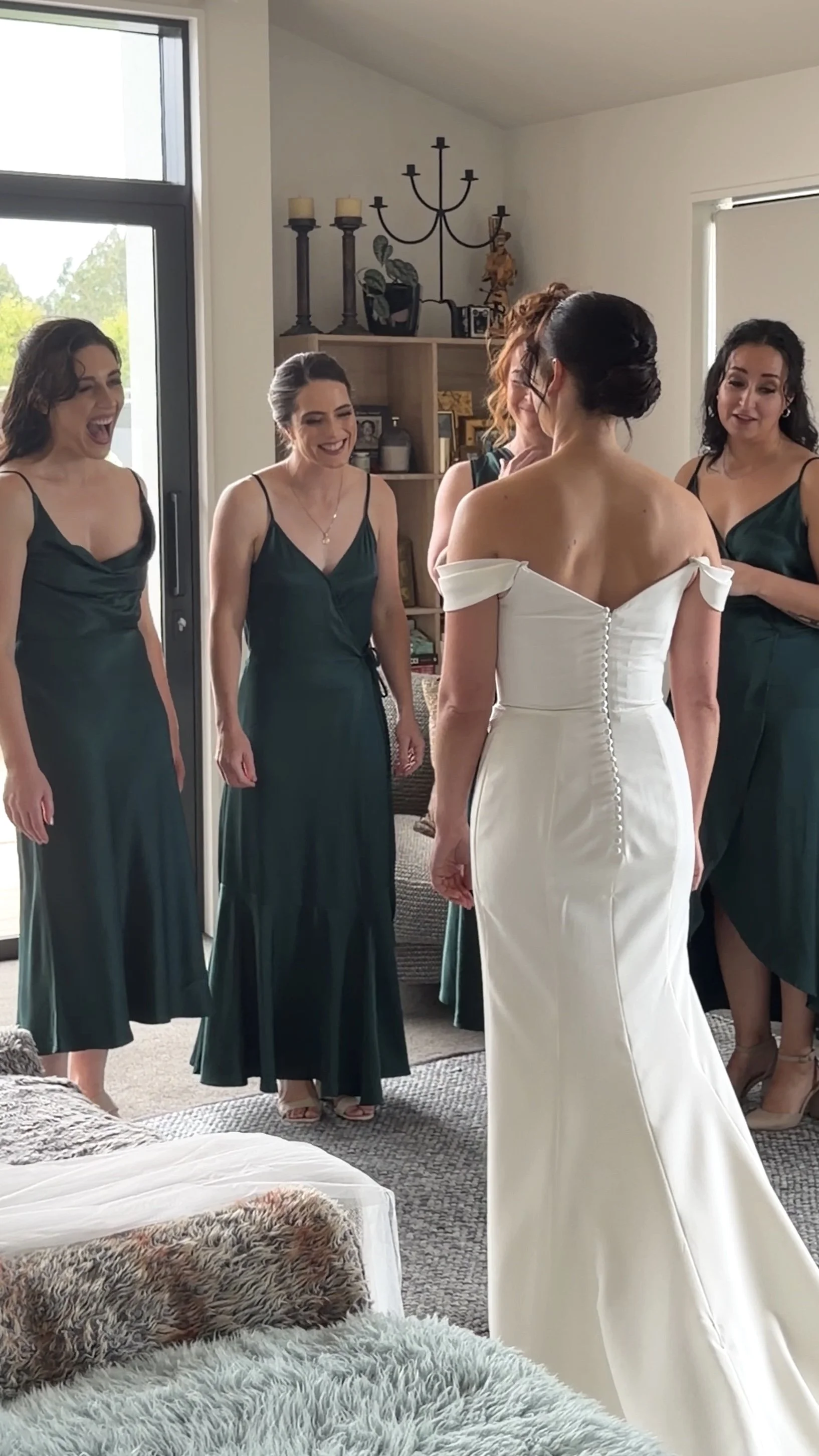 Bridesmaids reacting to the bride during the wedding morning preparations at a destination wedding.