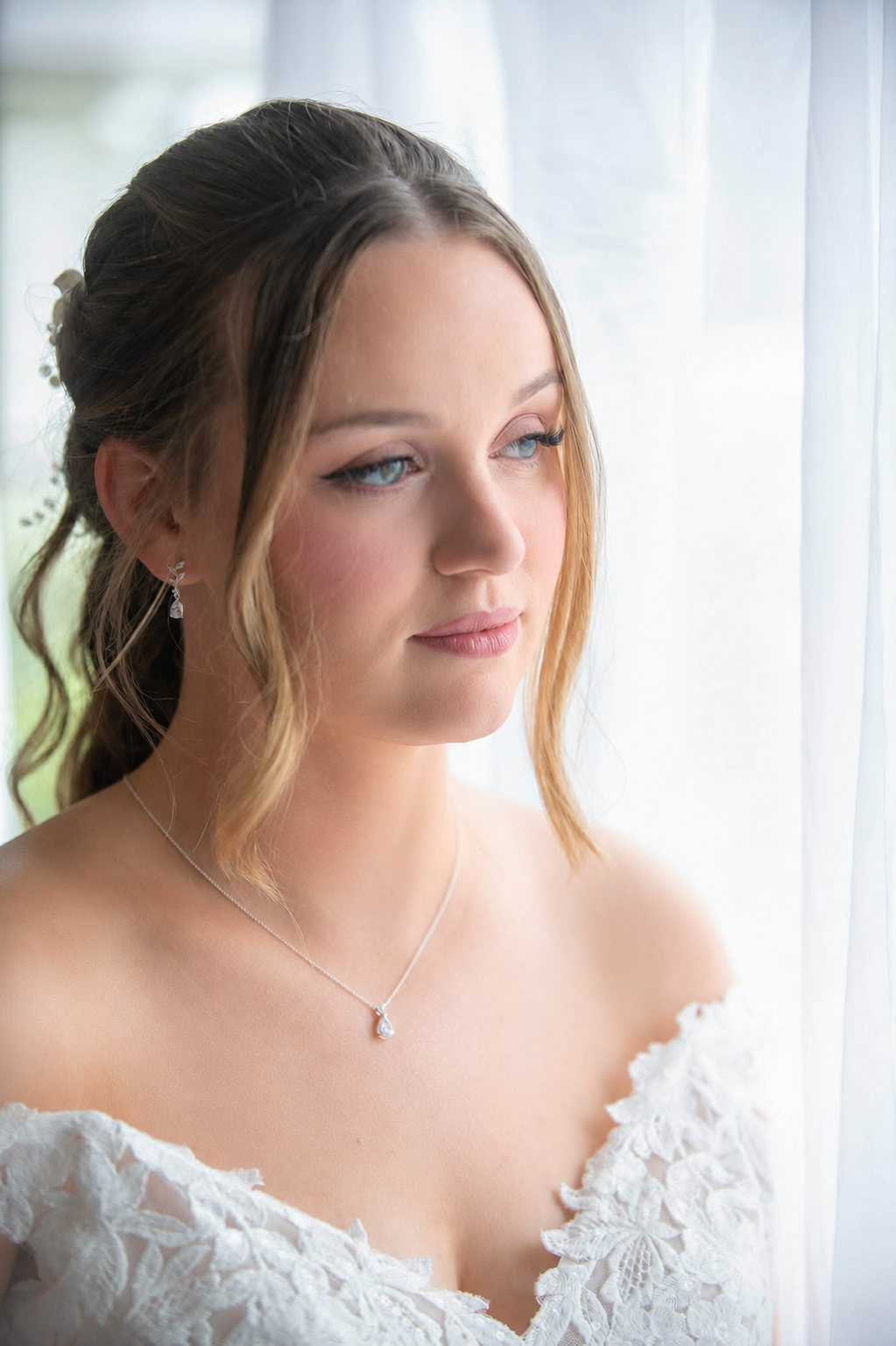 Bride wearing elegant natural bridal makeup by Rita Jacinto, Bridal Makeup Artist in Portugal, with radiant skin, soft pink tones and timeless wedding beauty in natural window light.