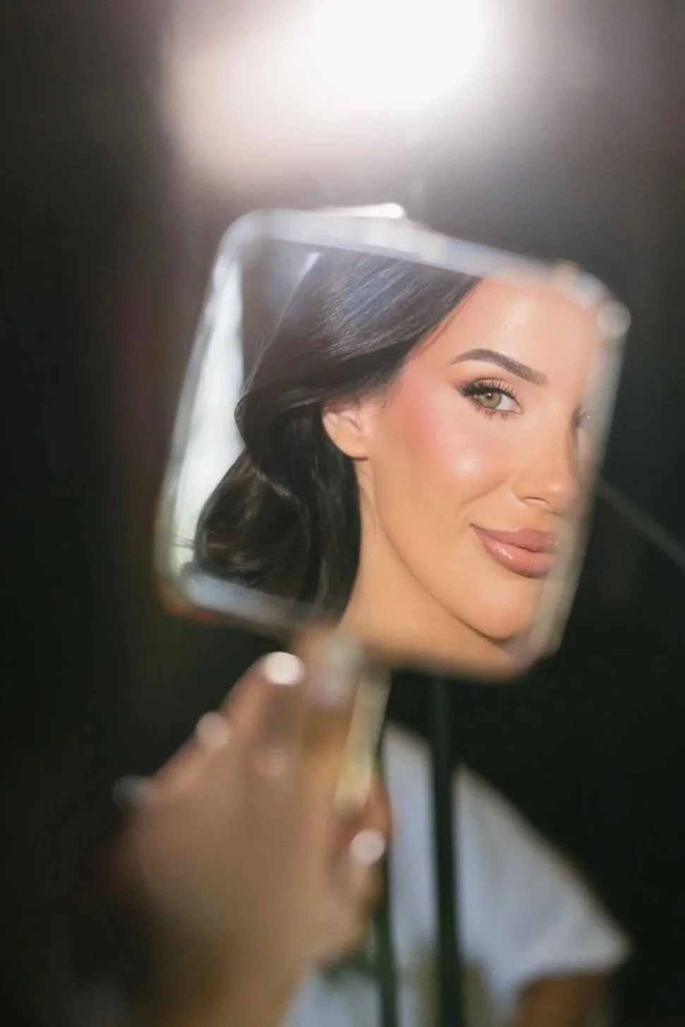 Bride seeing her wedding makeup look during the bridal preview trial session.