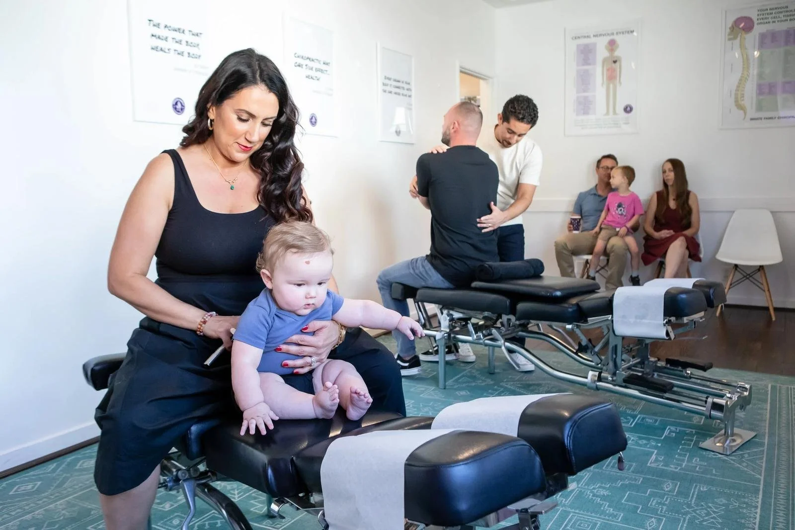 Dr. Adana Vargas of Innate Family Chiropractic Pasadena CA gently adjusting a baby on the chiropractic table.