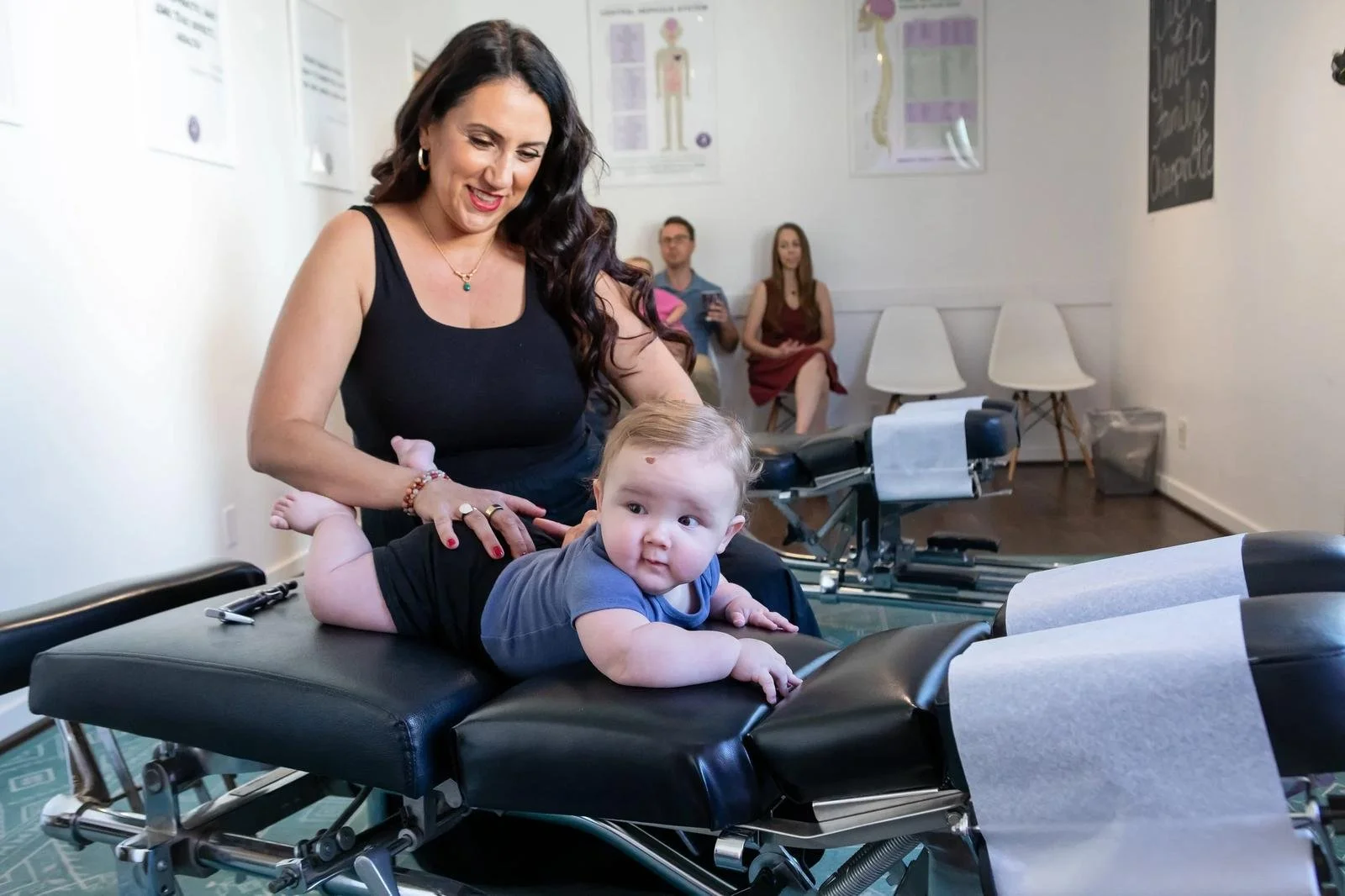 Dr. Adana Vargas of Innate Family Chiropractic Pasadena CA caring for an infant on the chiropractic table.