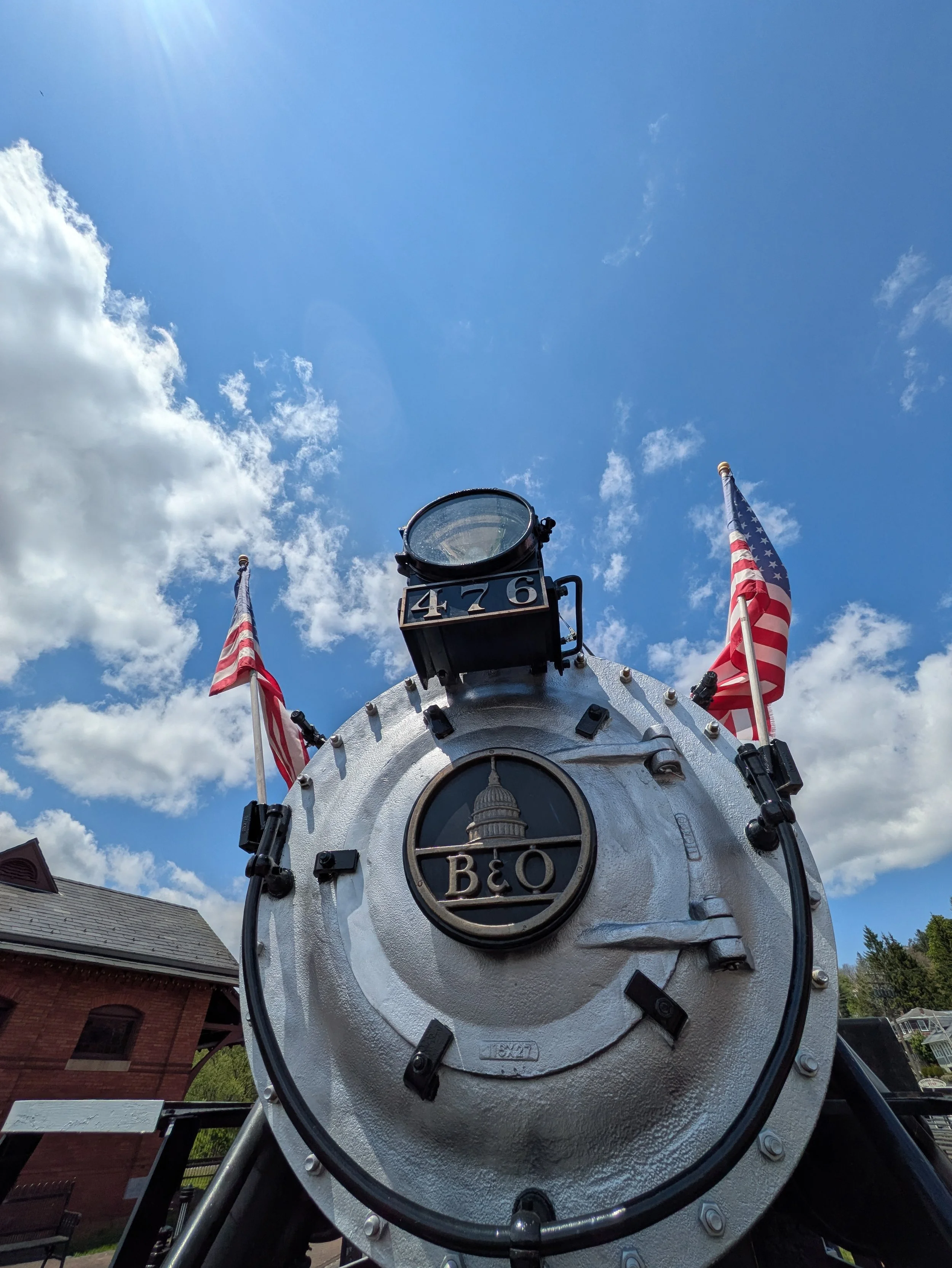 Historic steam locomotive front with B&O insignia and two American Flags on each side