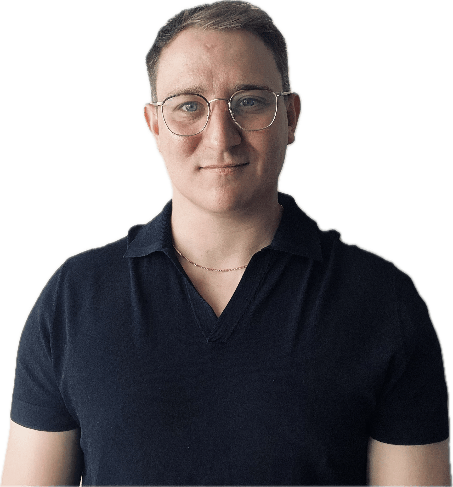 Portrait of a young man with short brown hair, glasses, wearing a black polo shirt and a thin necklace against a plain background.