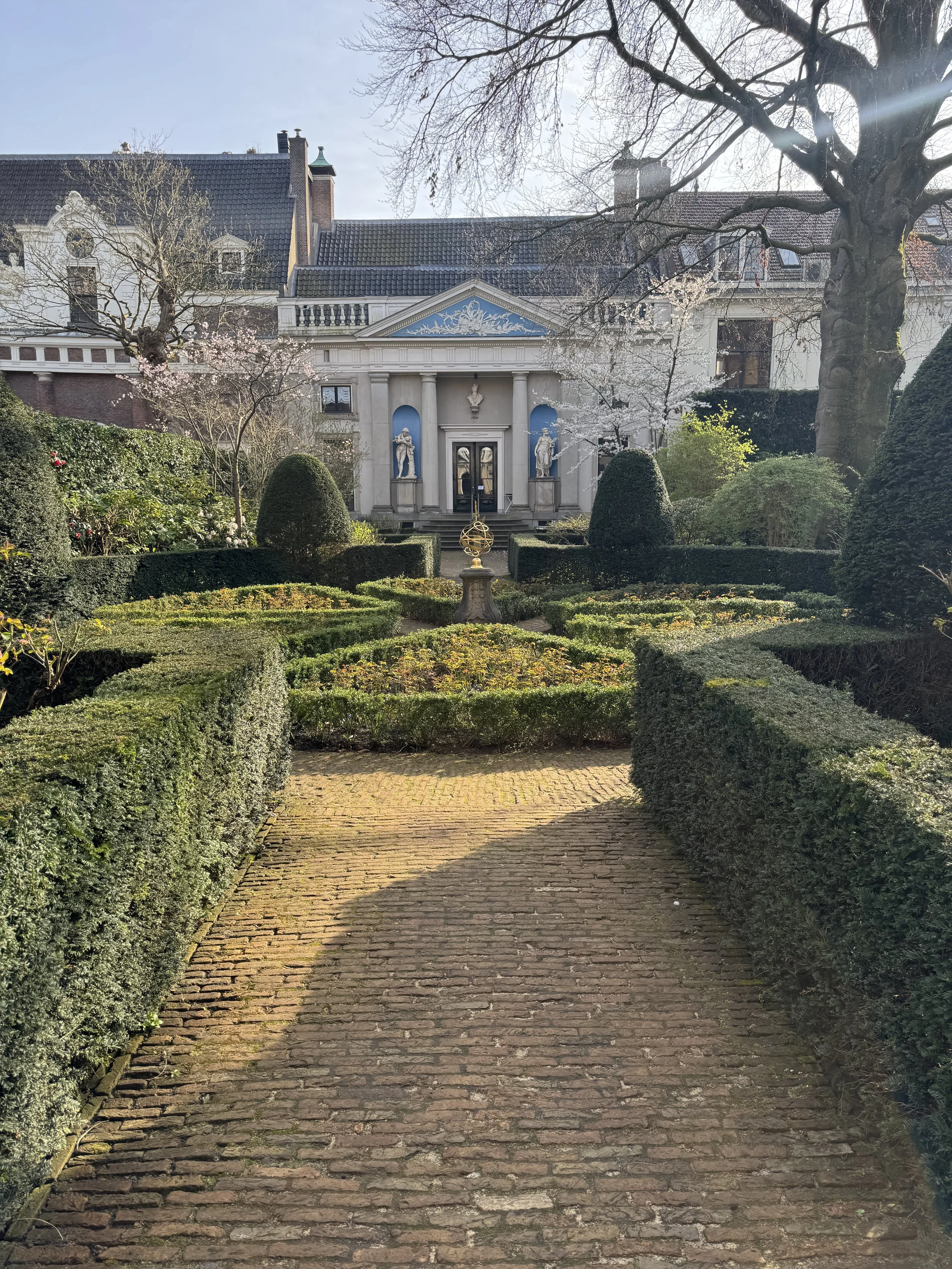 Formal garden with hedges and pathway behind Museum Van Loon in Amsterdam