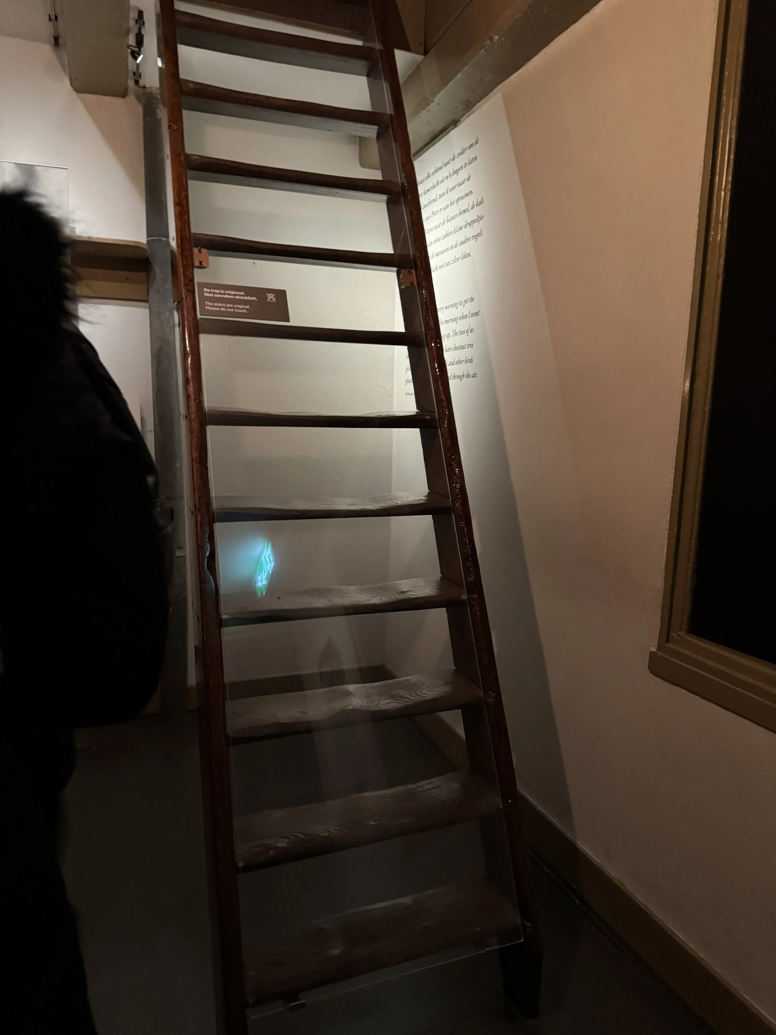 Narrow steep staircase inside the Anne Frank House reflecting the hidden annex layout