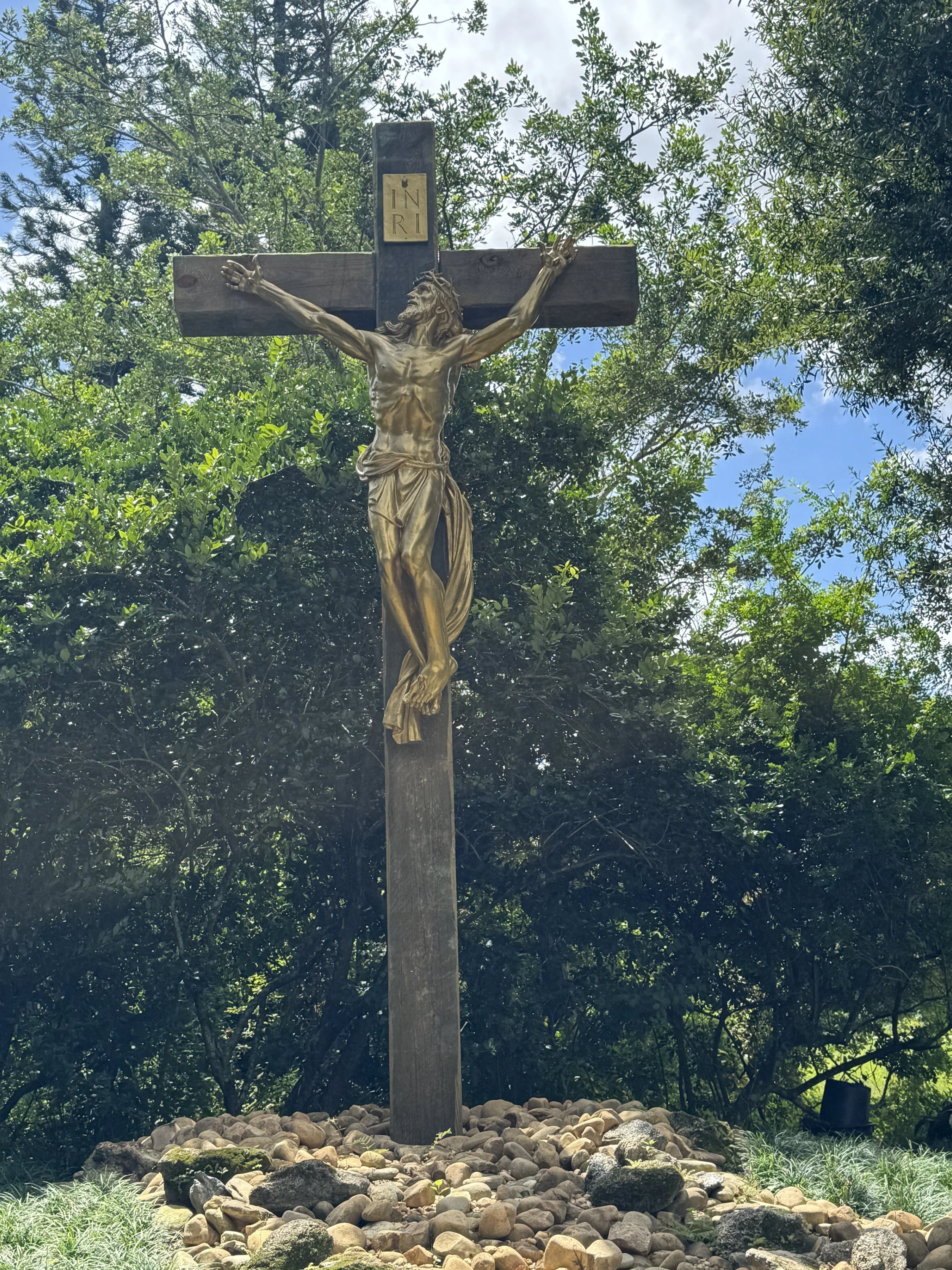 Large crucifix statue in the garden at the Albin Polasek Museum & Sculpture Gardens in Winter Park Florida.