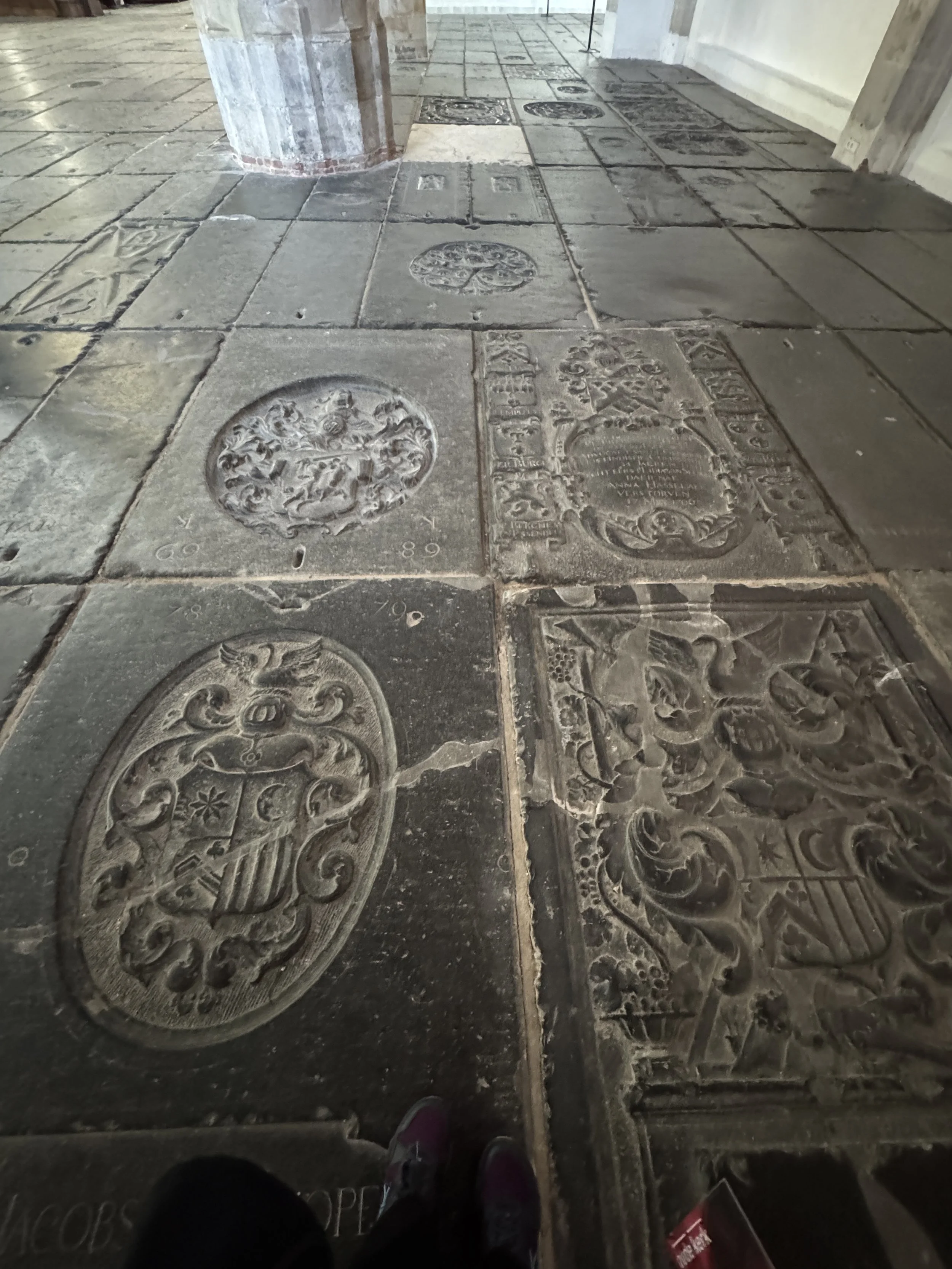 Stone floor covered with historic grave markers inside Oude Kerk Amsterdam