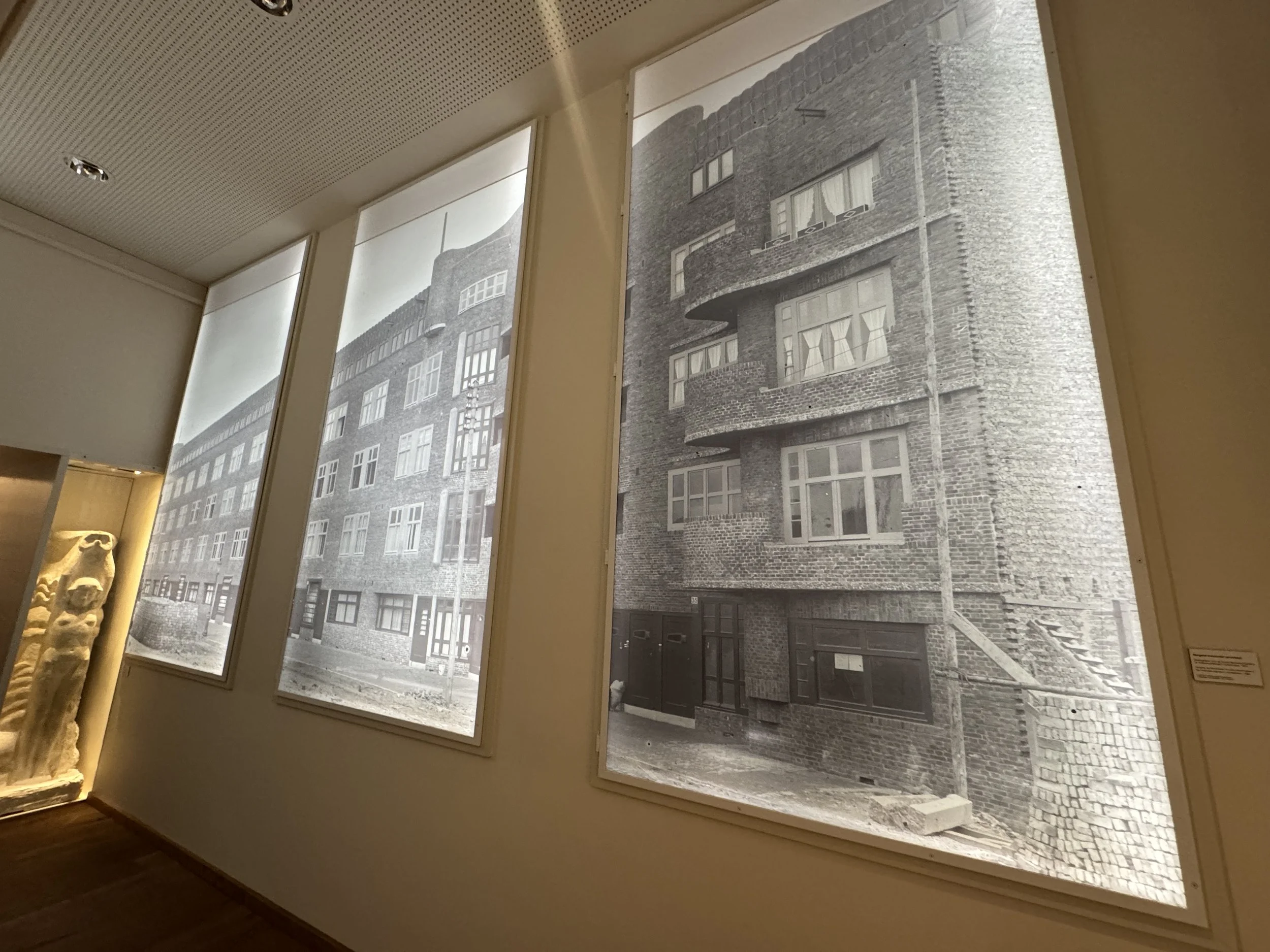 Interior view at Museum Het Schip with large windows displaying historic building facade through patterned glass