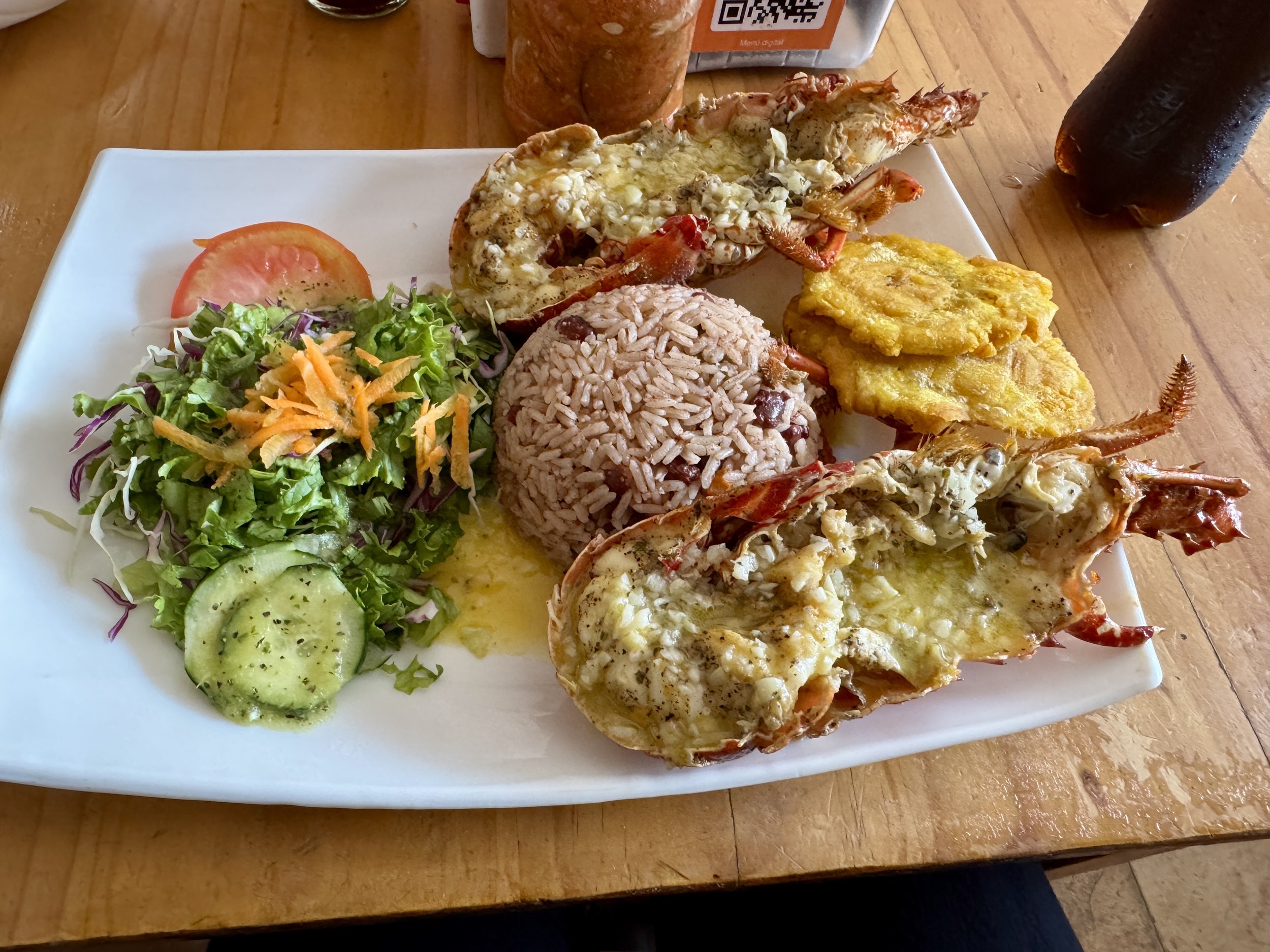 Lobster meal with rice, beans, corn, and vegetables at Cocomar in Puerto Viejo.