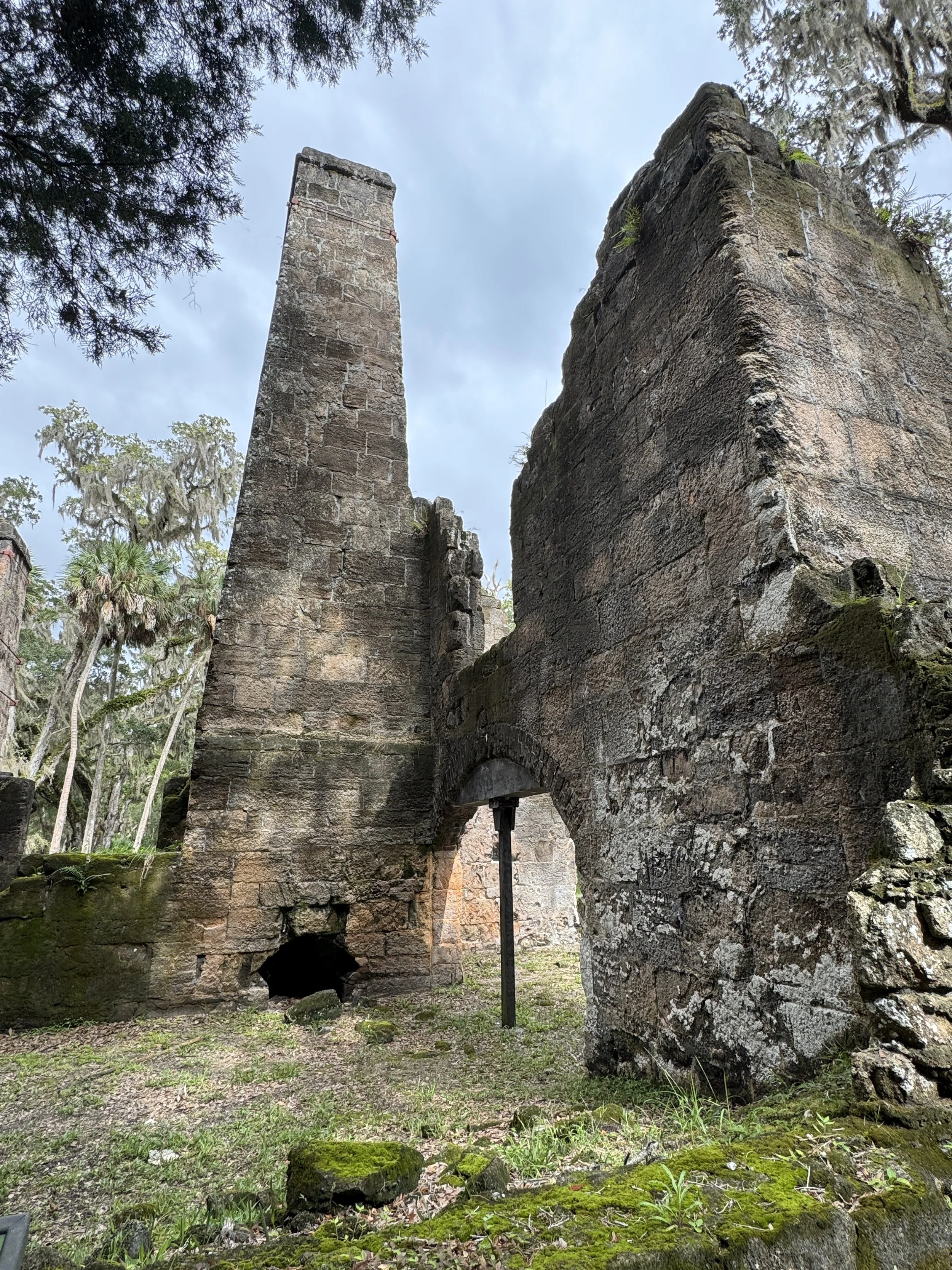 Tall brick chimney and stone walls from the former sugar mill at Bulow Plantation Ruins Historic State Park.