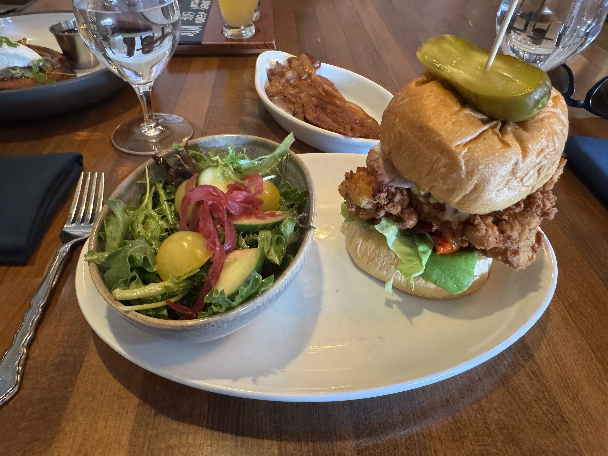 Chicken cordon bleu sandwich with salad served at The Ravenous Pig restaurant in Winter Park Florida.