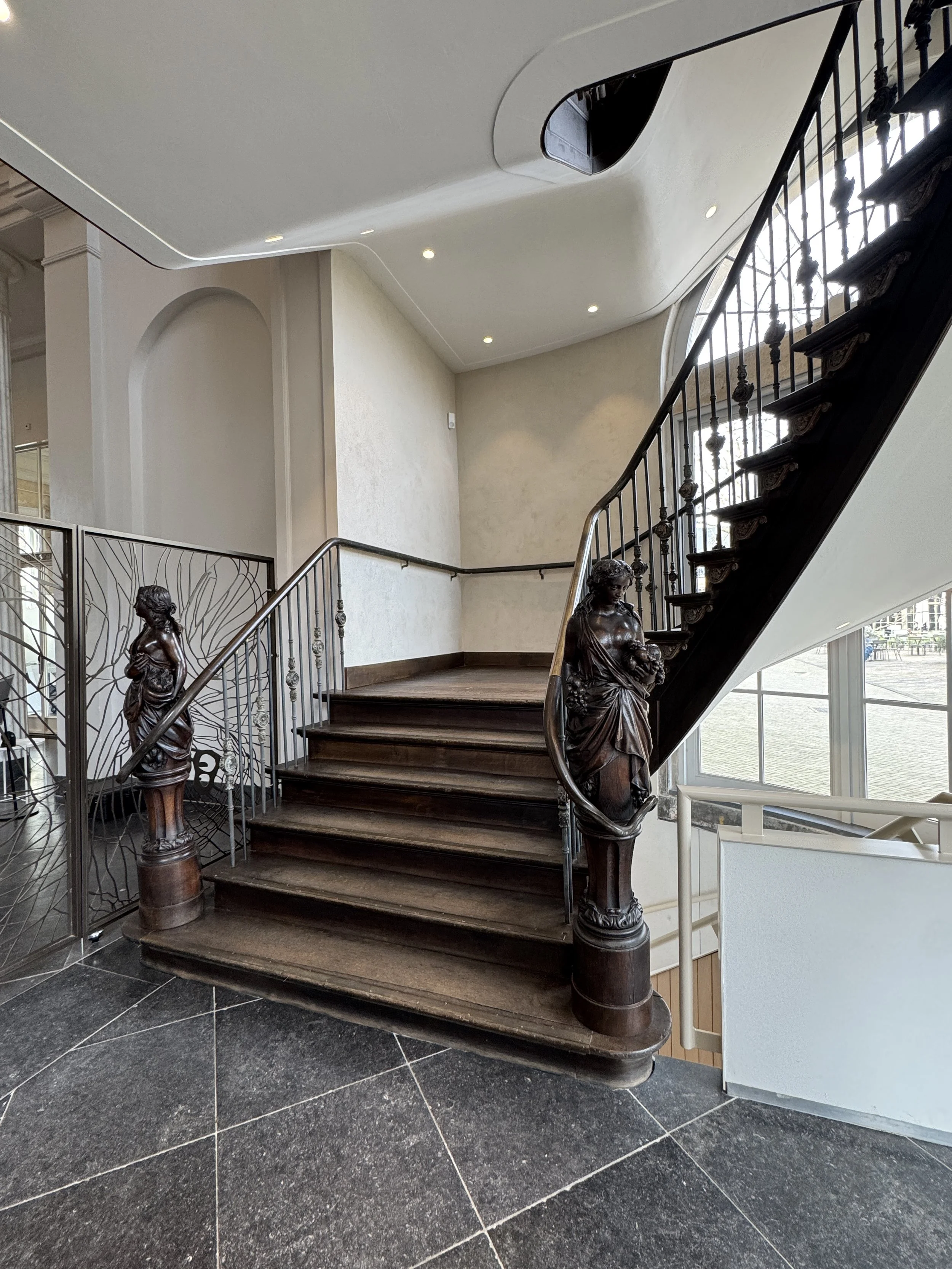 Interior staircase with ornate railings inside ARTIS-Groote Museum in Amsterdam