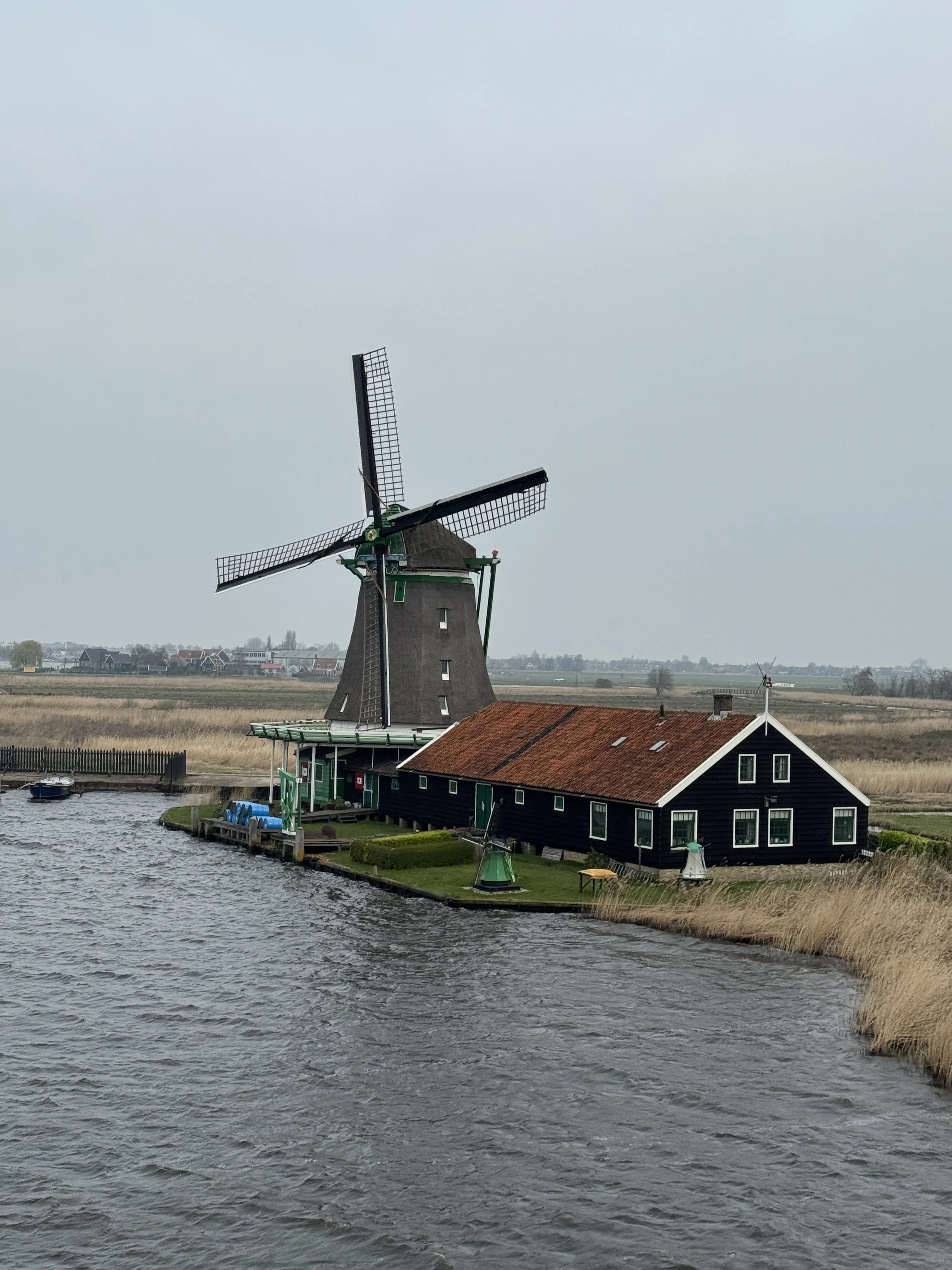 Traditional Dutch windmill along the water at Zaanse Schans in the Netherlands