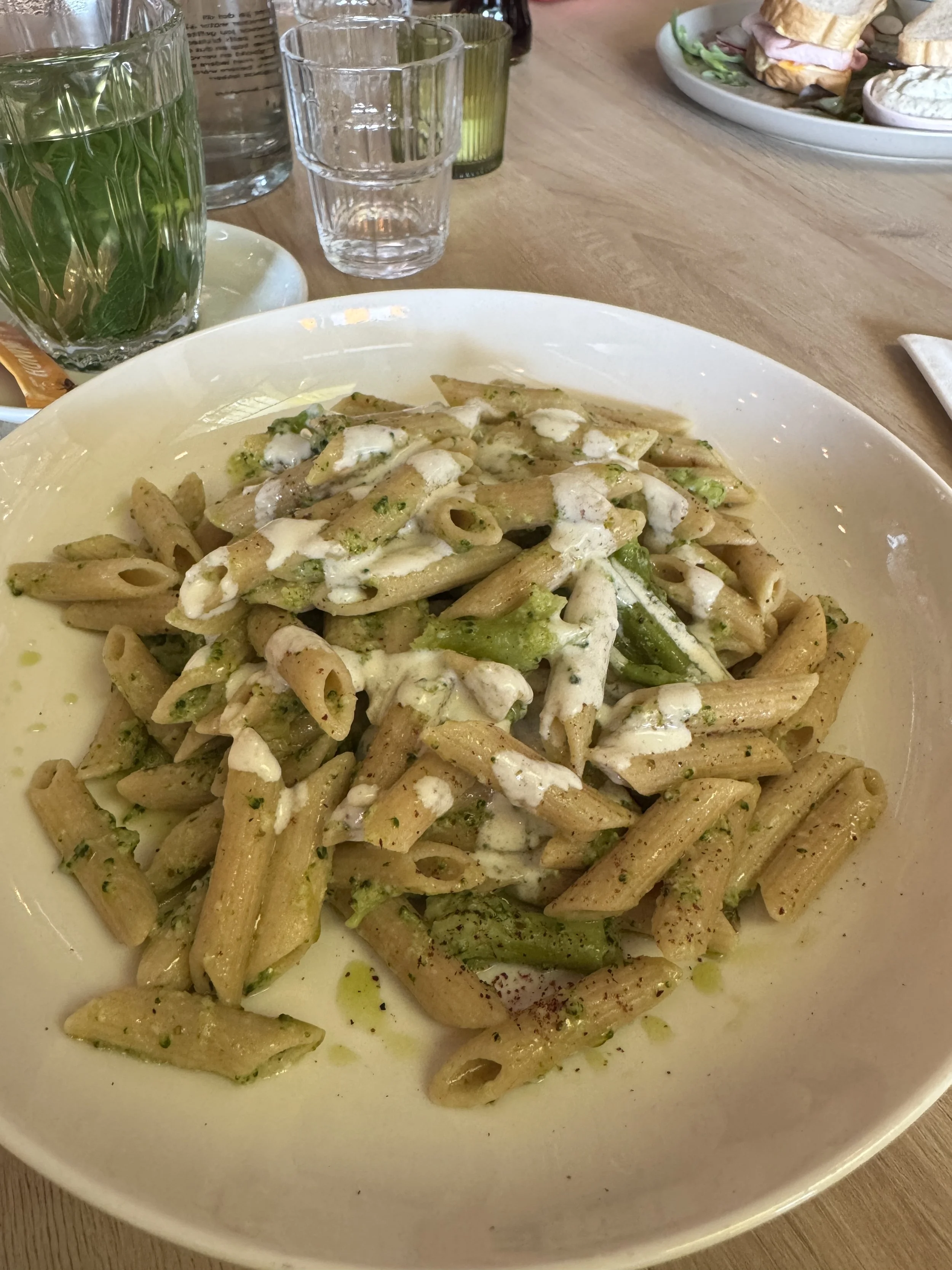 Plate of homemade pasta with broccoli and creamy sauce at Your Daily Domus in Amsterdam