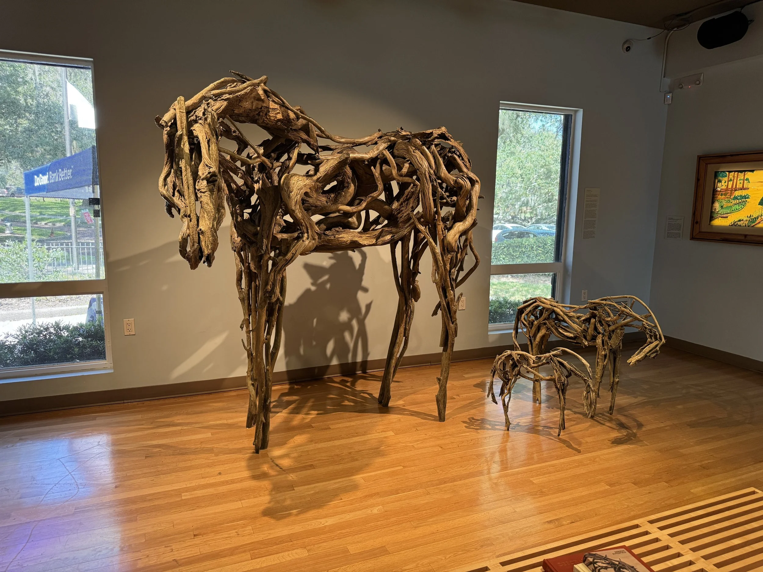 Large driftwood horse sculpture displayed inside the Mennello Museum of American Art in Orlando.
