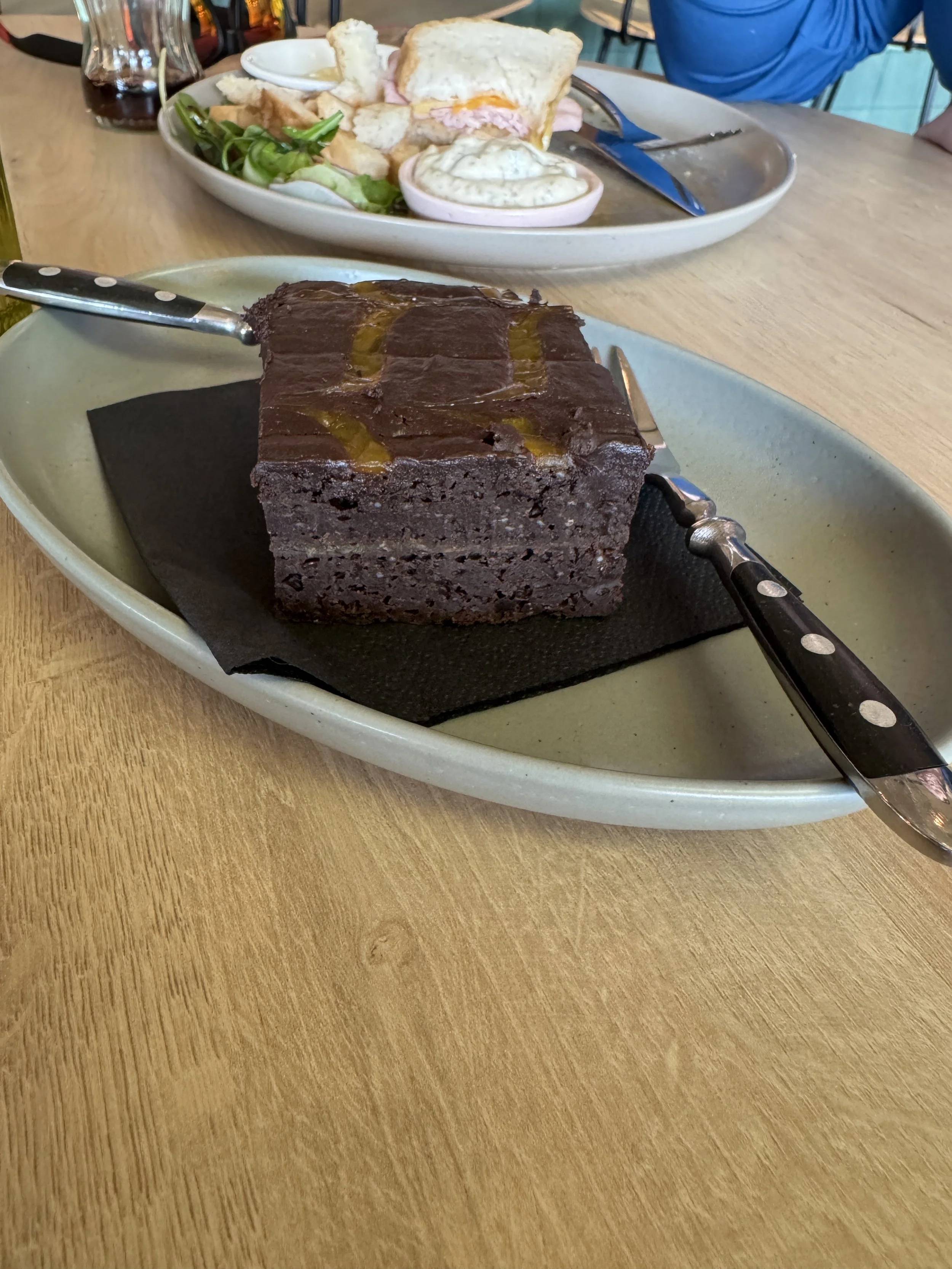 Rich vegan chocolate brownie dessert served on a plate at Your Daily Domus restaurant in Amsterdam