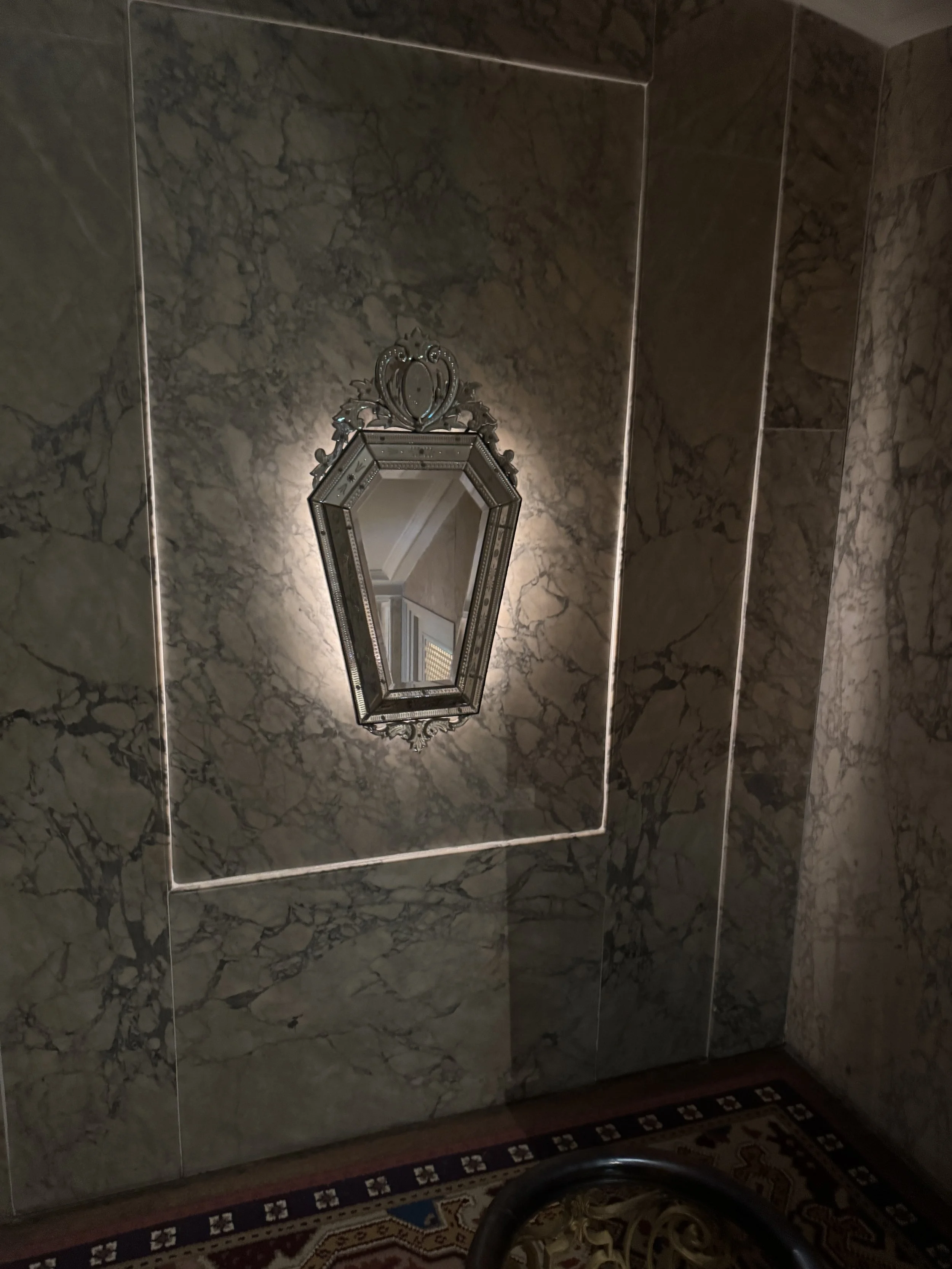 Decorative wall feature with framed lantern-style fixture inside Huis Willet-Holthuysen in Amsterdam