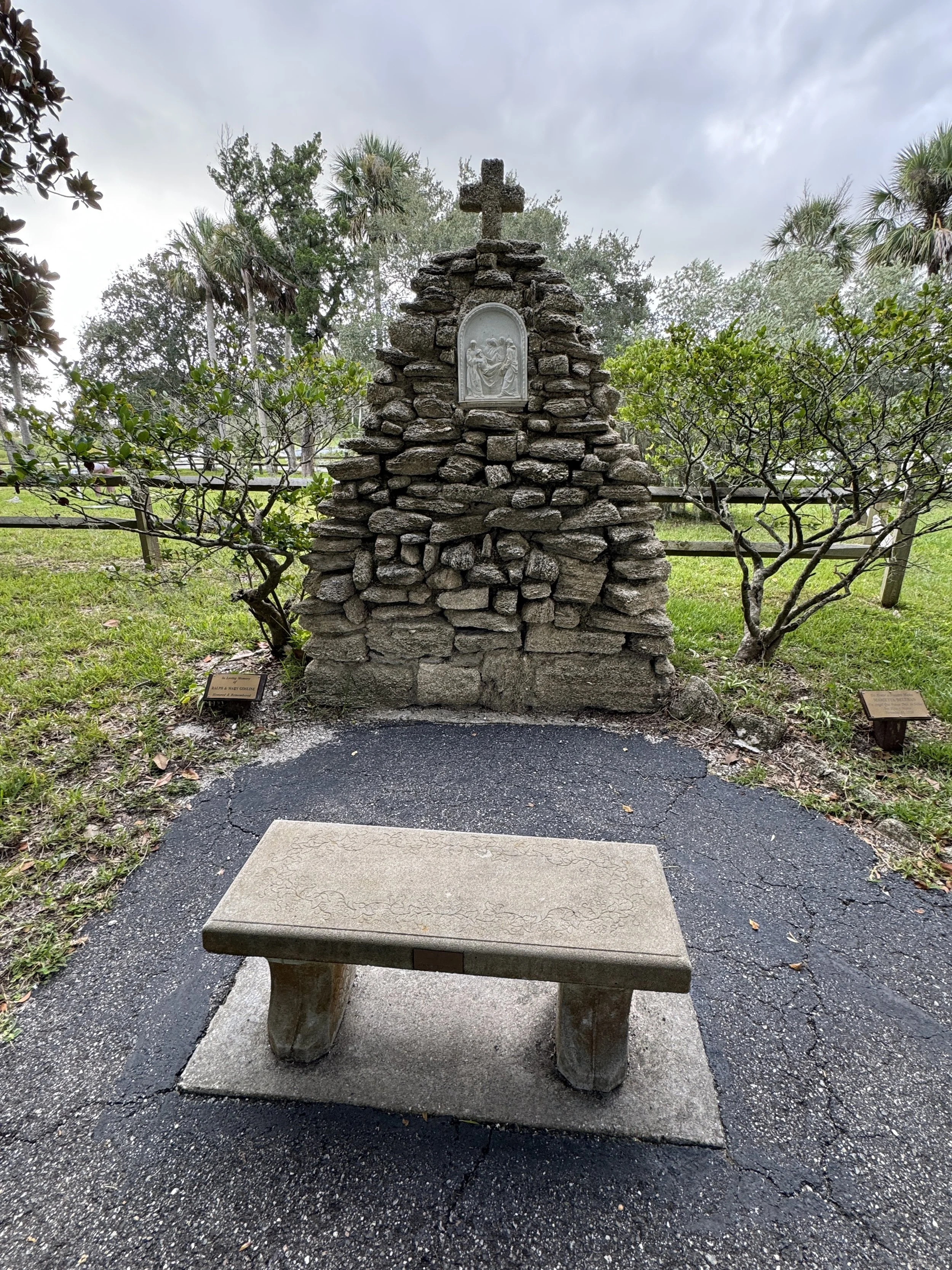 Stone monument and memorial bench at the National Shrine of Our Lady of La Leche in St. Augustine Florida.