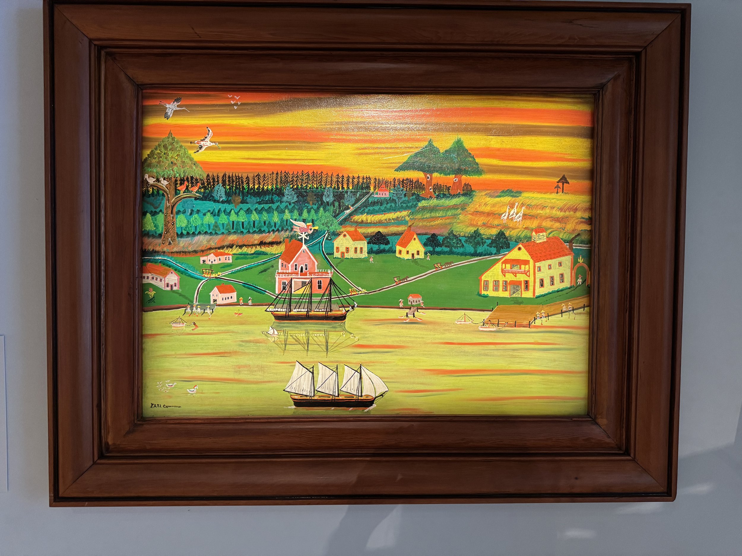 Colorful framed landscape painting displayed at the Mennello Museum of American Art in Orlando Florida.