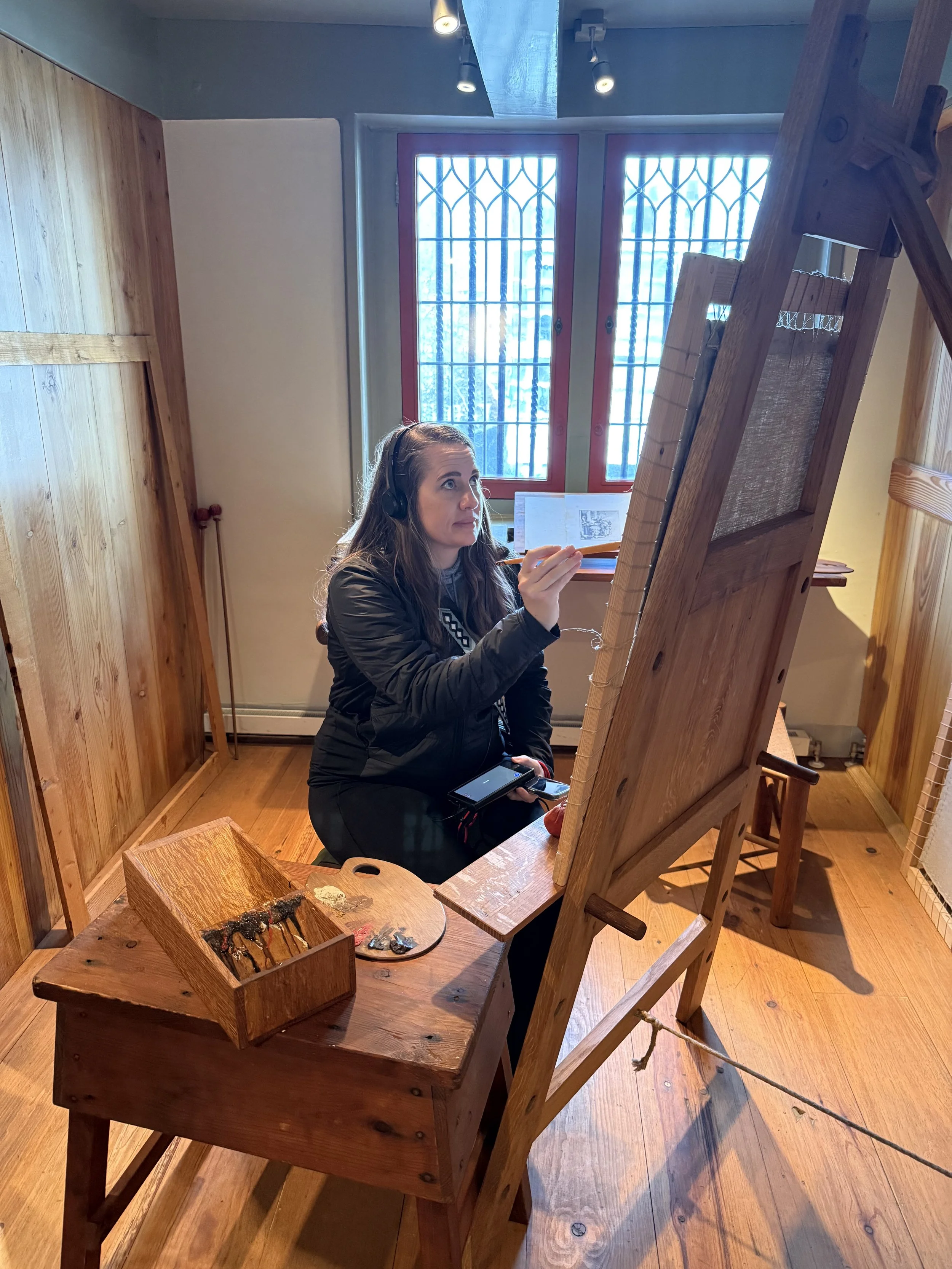 Artist demonstrating painting techniques in a studio at Rembrandt House Museum Amsterdam