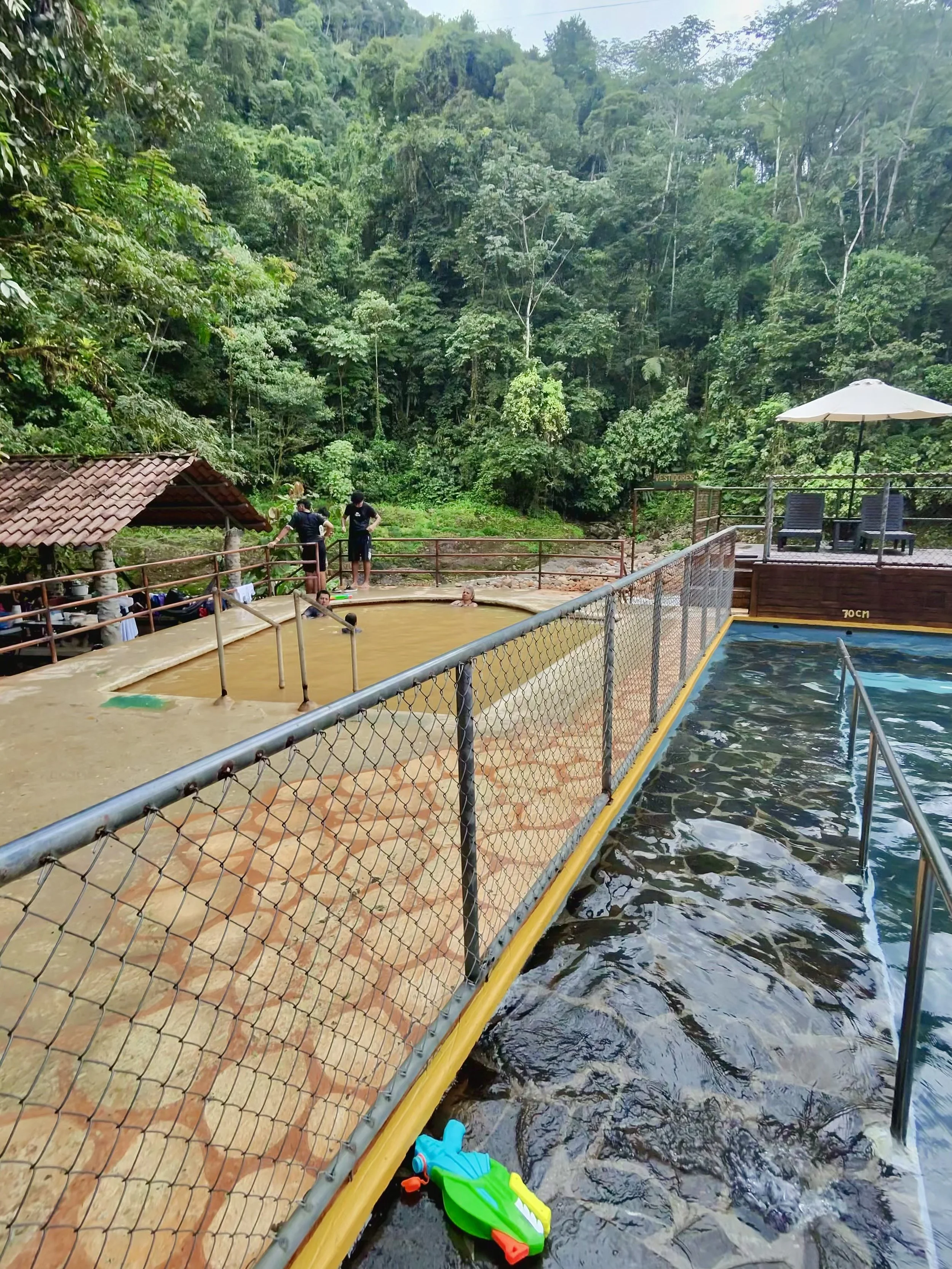Cold spring water pool with stone walkway and railing at Recreo Verde.