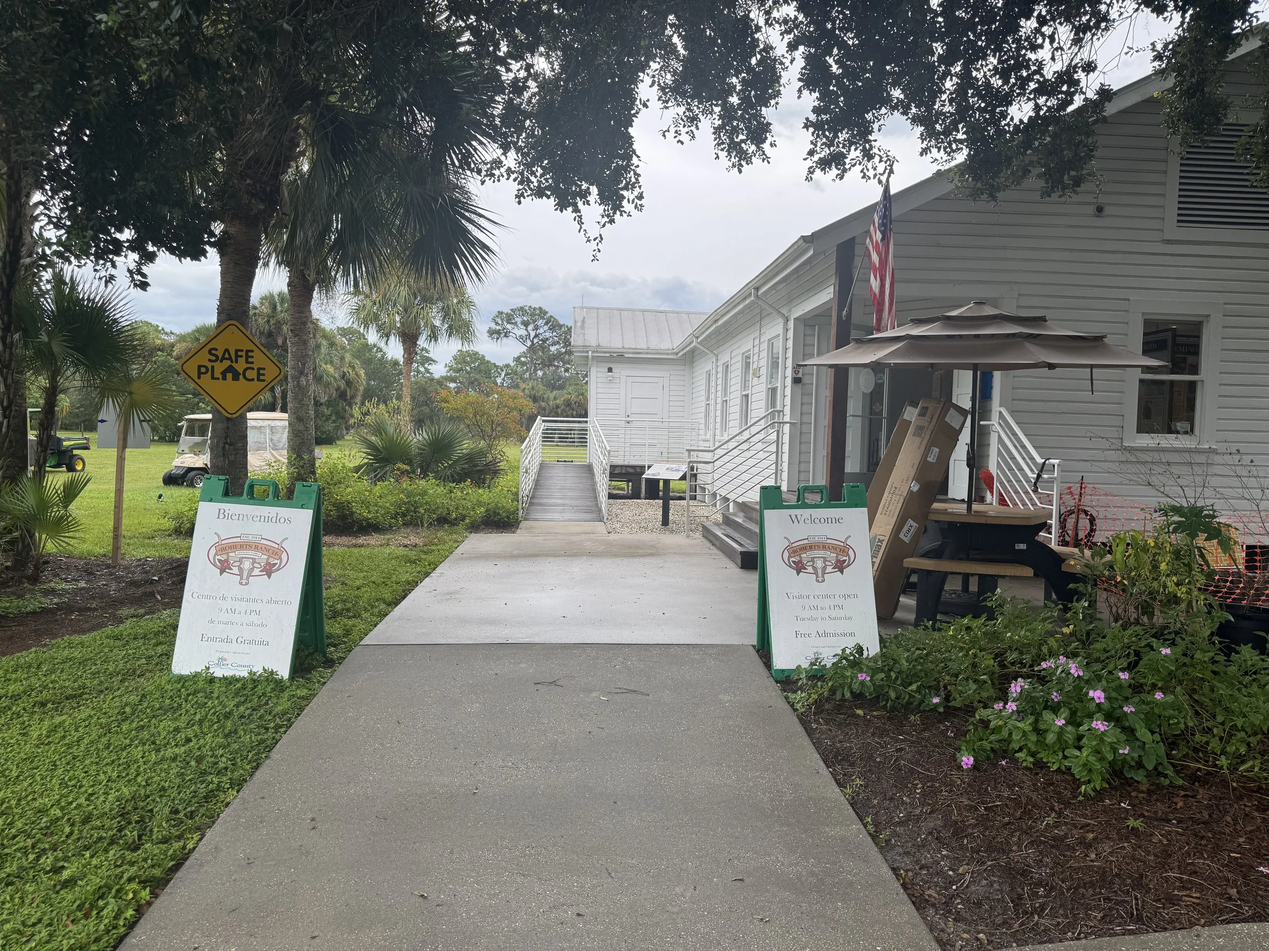 Immokalee Pioneer Museum entrance walkway at Roberts Ranch in Fort Myers, Florida with historic buildings and landscaped path.