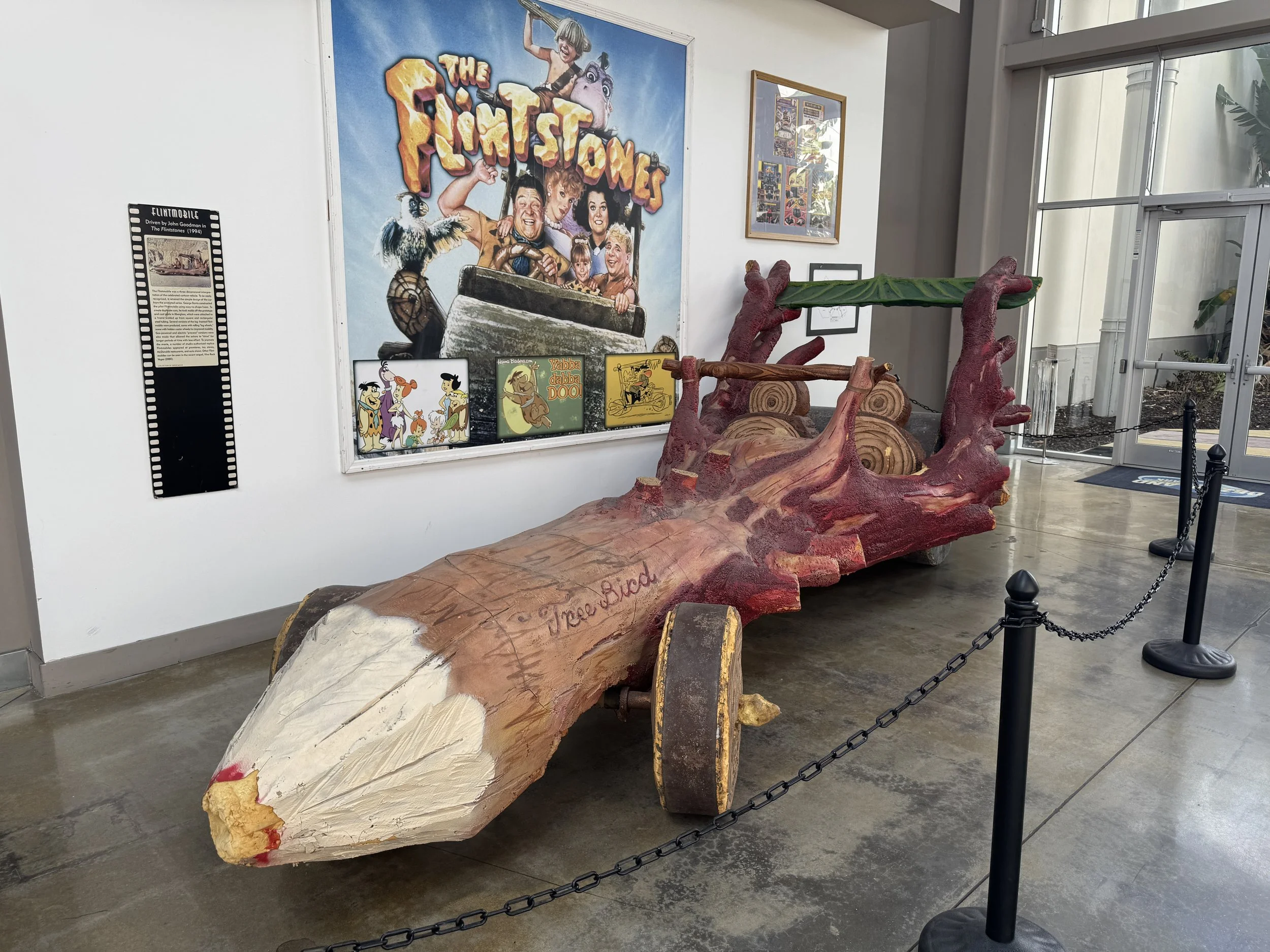 original flintstones movie prop car made from a carved log on display at Dezerland Park Orlando