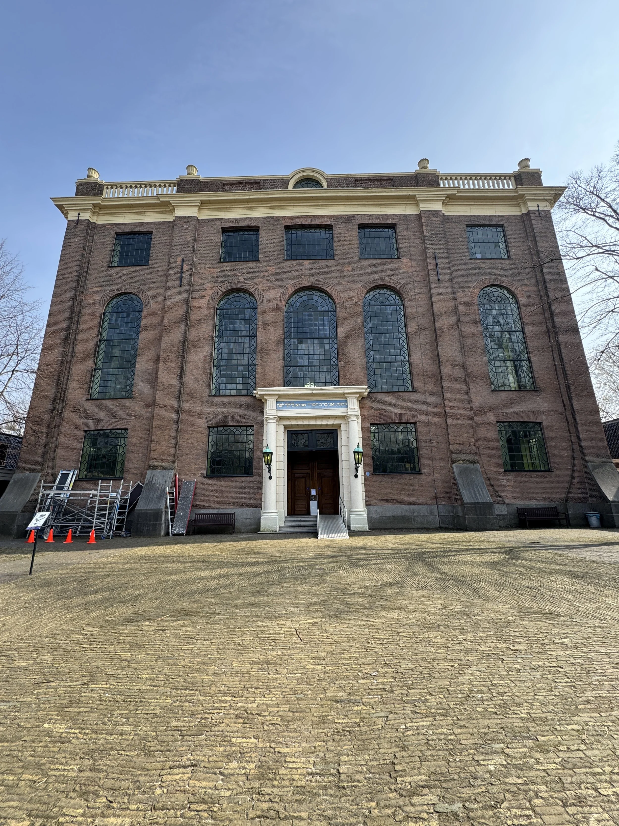 Exterior of the Portuguese Synagogue in Amsterdam with historic brick facade and arched windows