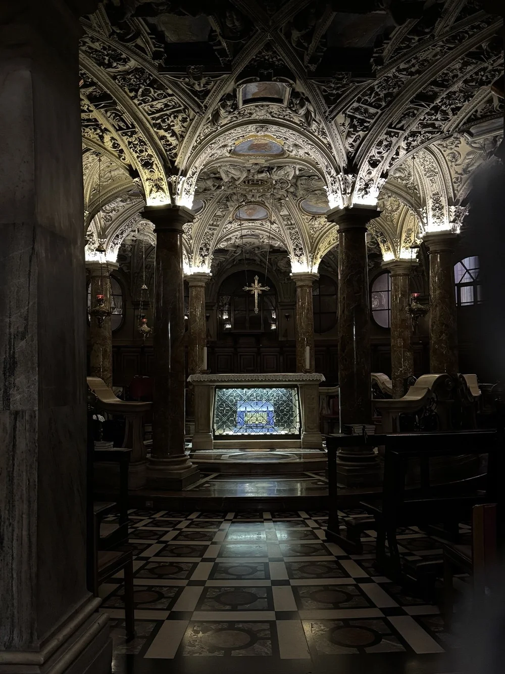 Crypt of Saint Charles Borromeo beneath Milan Cathedral with an illuminated shrine and vaulted ceiling